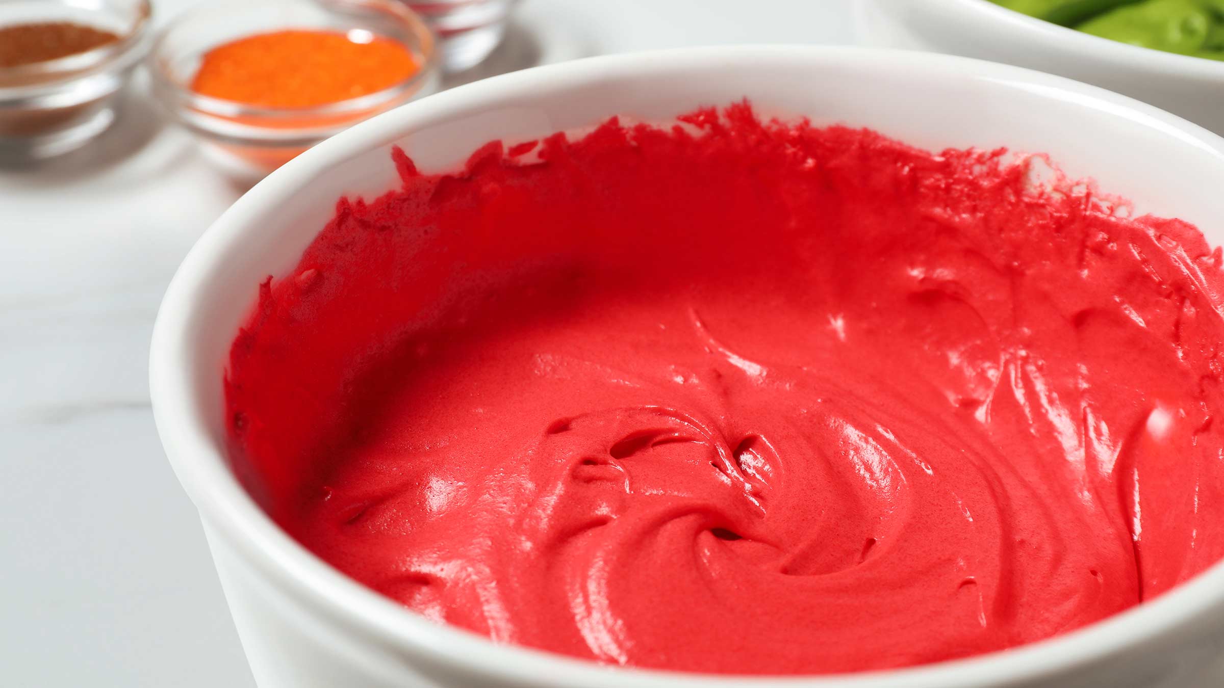 A bowl of cream dyed with red food dye