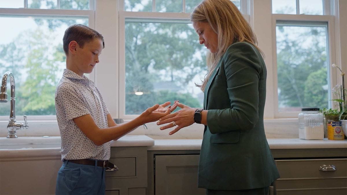 Dr. Moore looking at Byron's hands