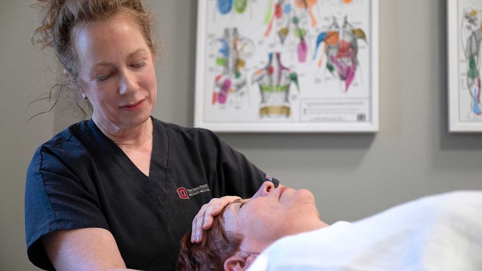 An Ohio State massage therapist giving a woman a massage