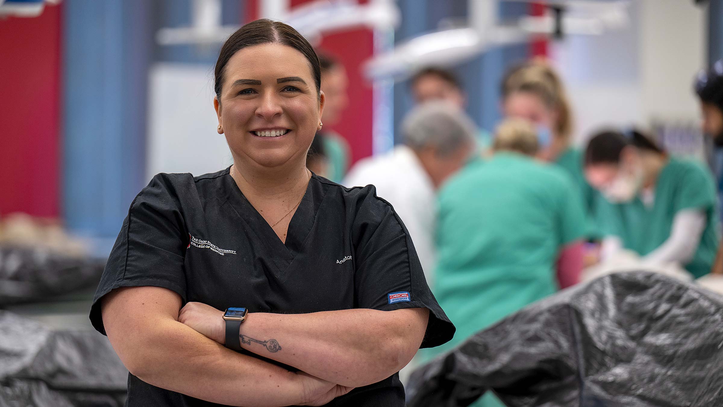 Melissa Quinn, PhD, smiles while standing in dissection lab