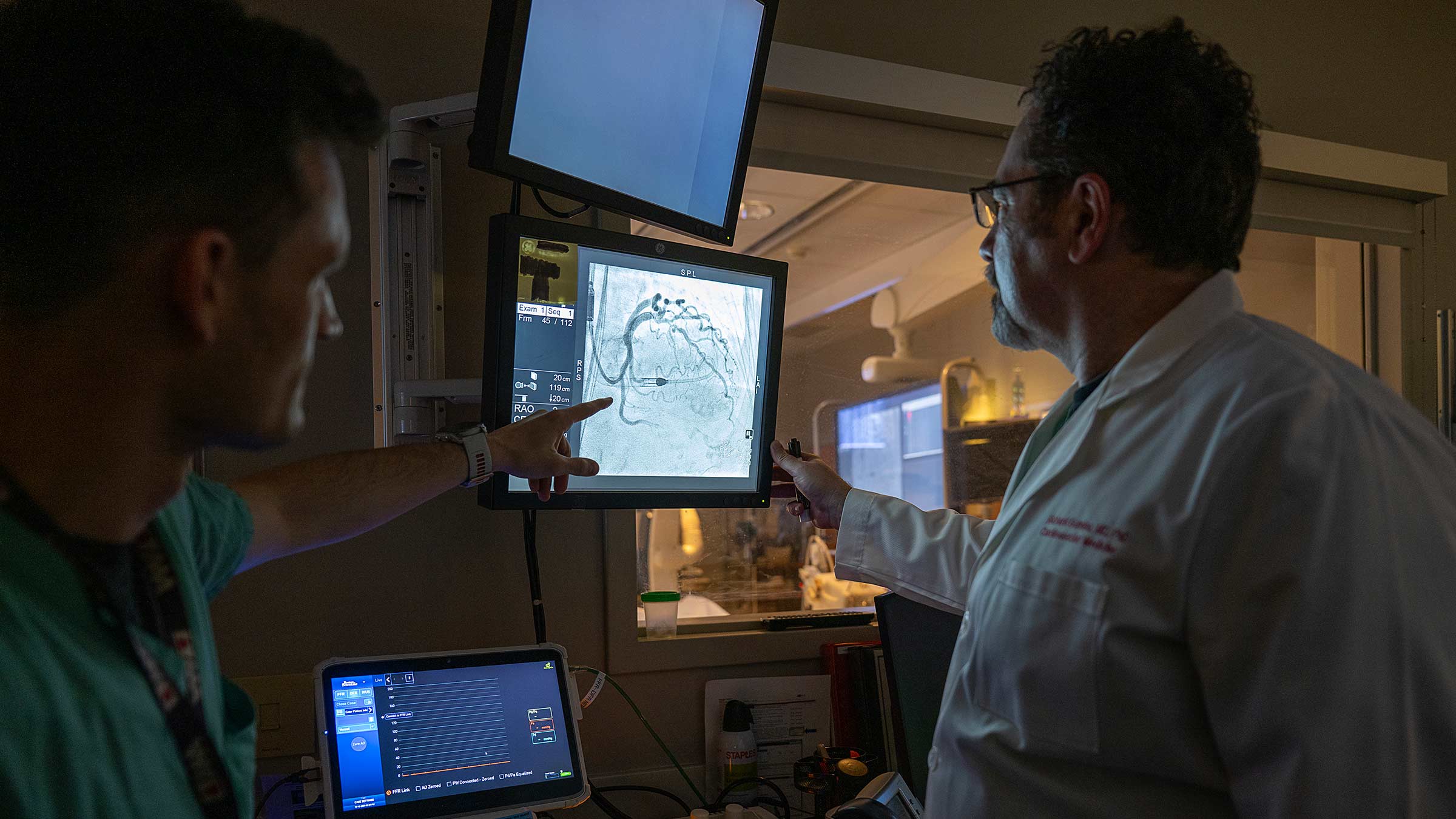 Dr. Gumina pointing to an image of blood vessels on a screen