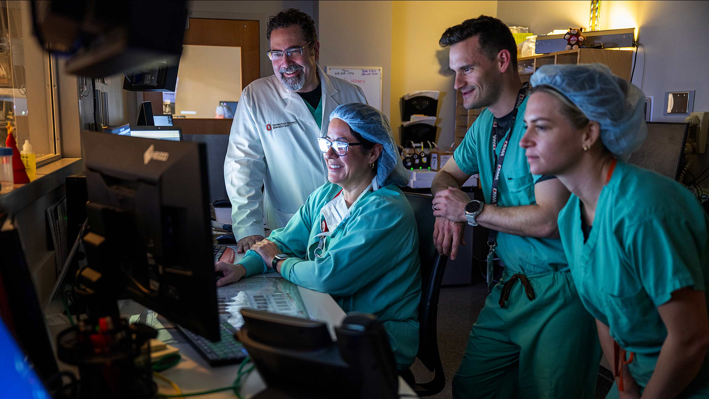 Dr. Gumina with his team looking at a computer screen