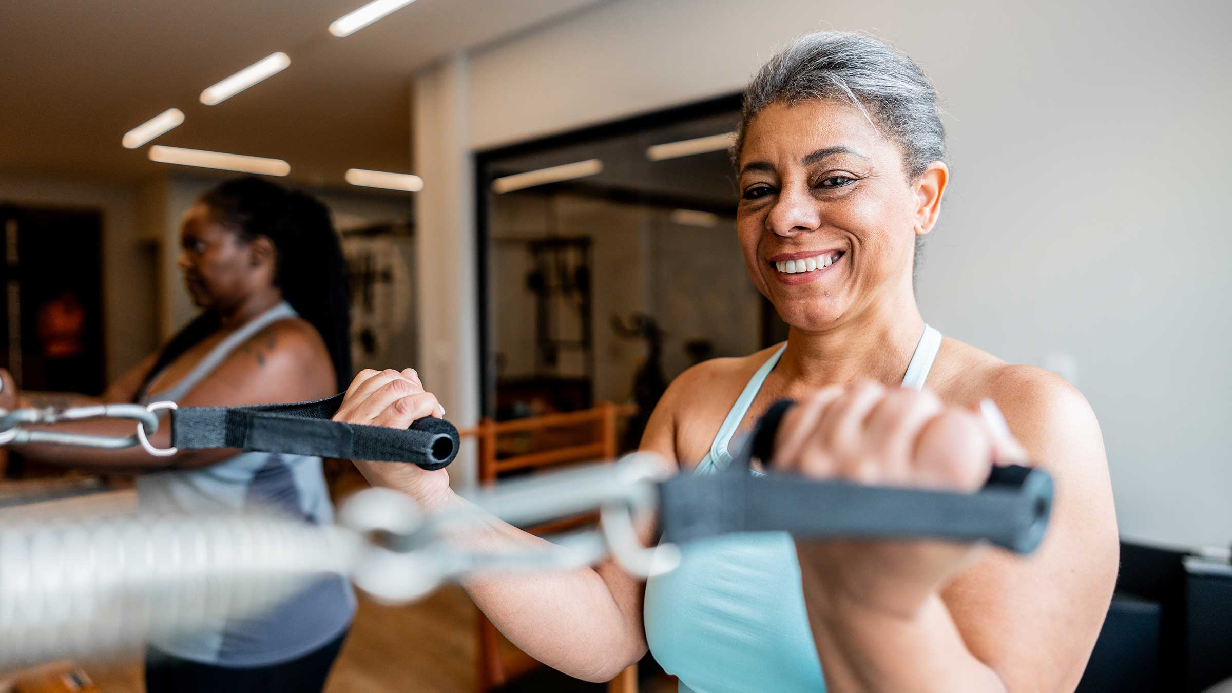 A woman exercising in a Pilates studio