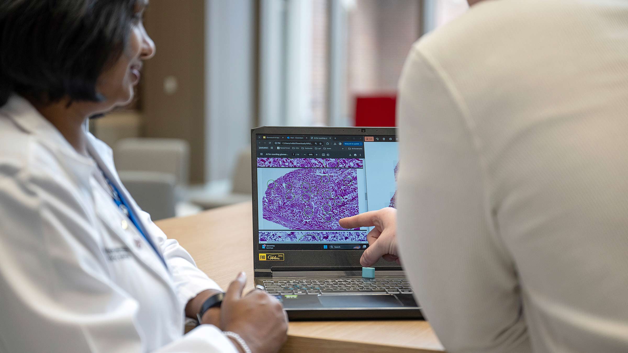 Appathon students observing close-up, digital images of glomeruli on a computer screen