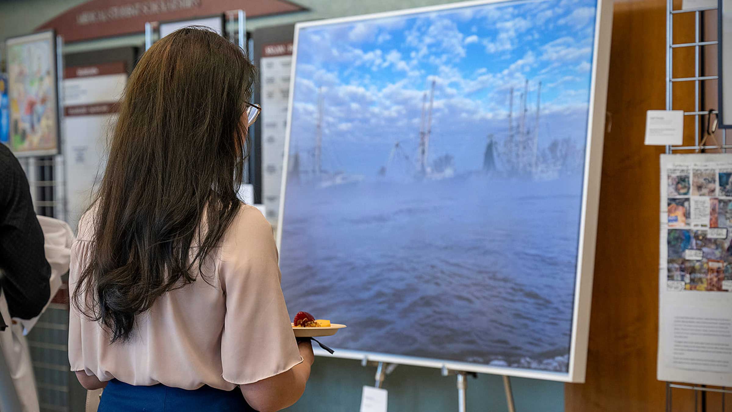 Natalie Brillhart viewing a painting at an art show