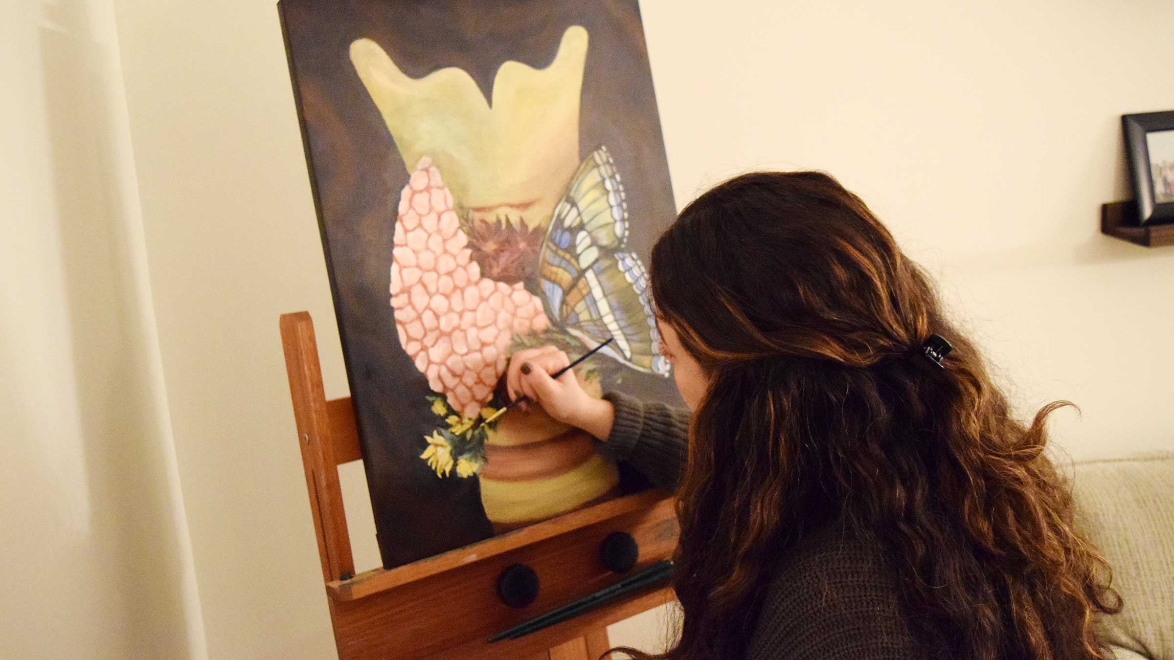 Natalie Brillhart painting an image of a thyroid gland and a butterfly