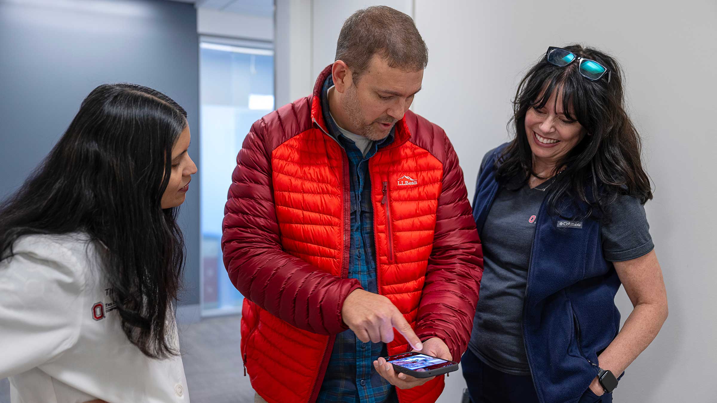 Todd Burnworth showing photos on his phone to his care team