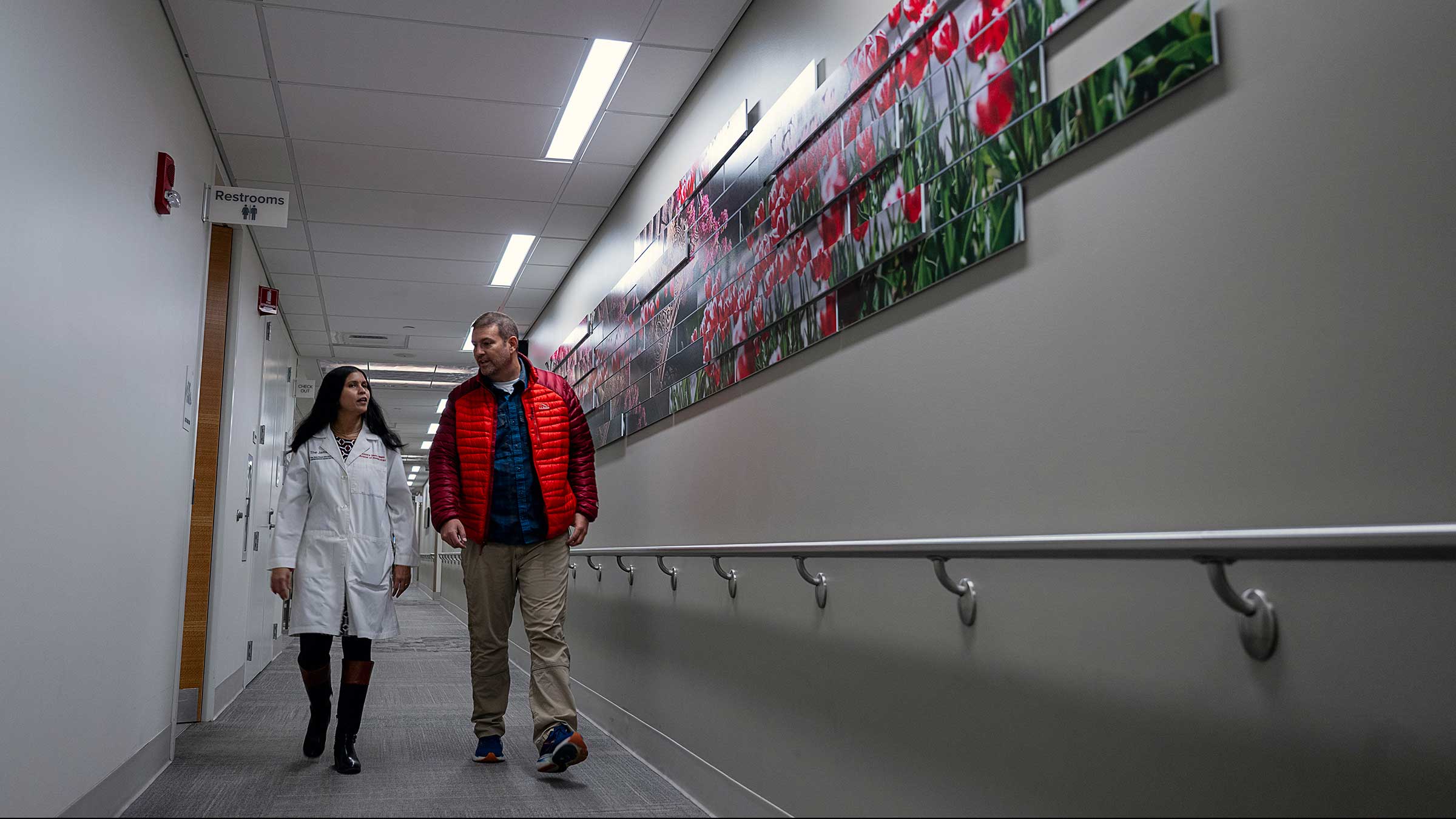 Todd Burnworth walking with Dr. Vasu in the hallway