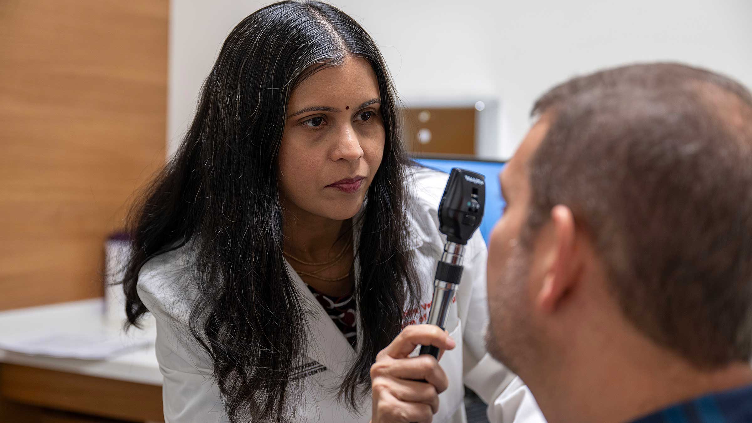 Dr. Vasu examining a patient