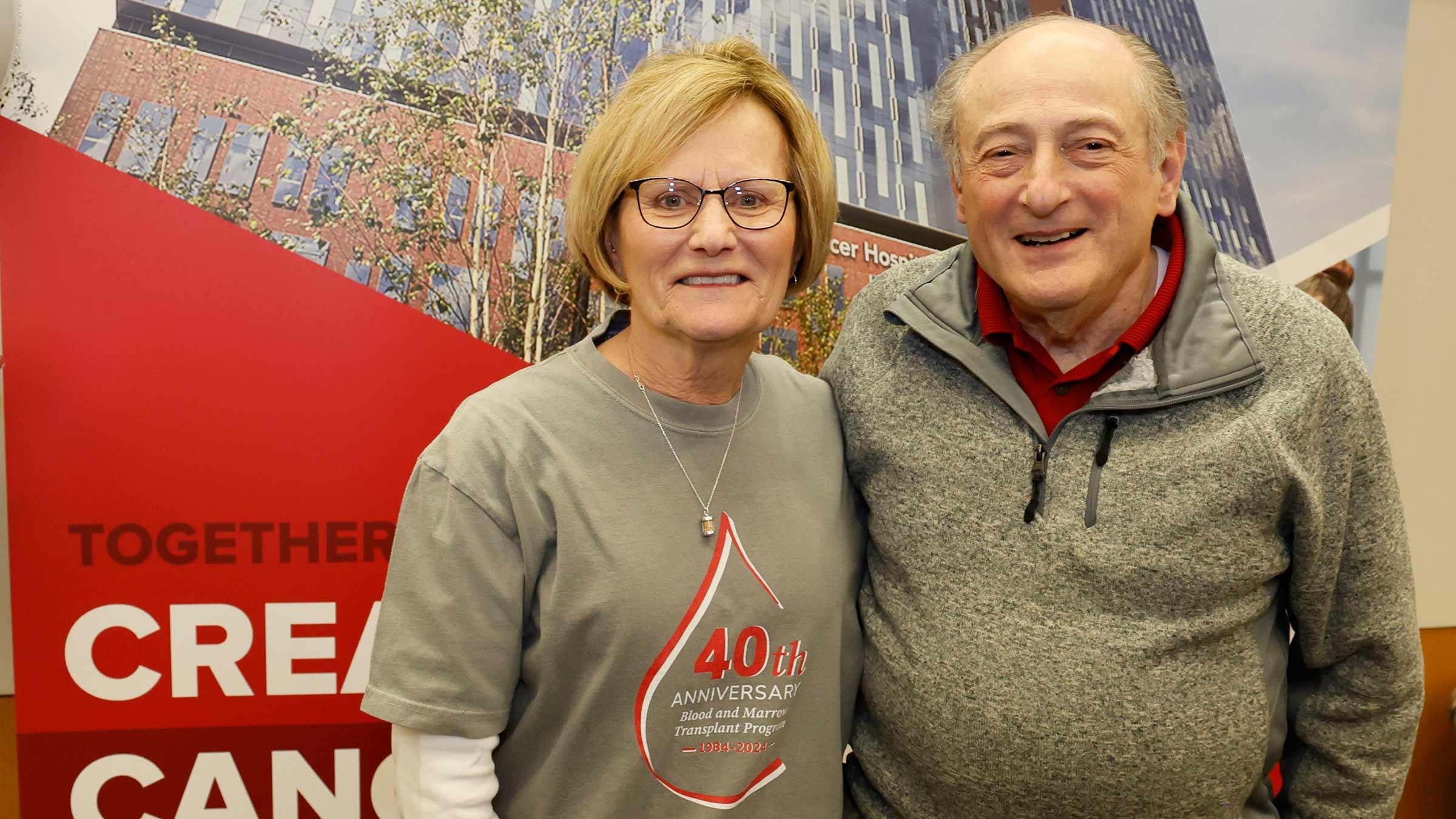 Fran posing with man at the 40th anniversary BMT program event