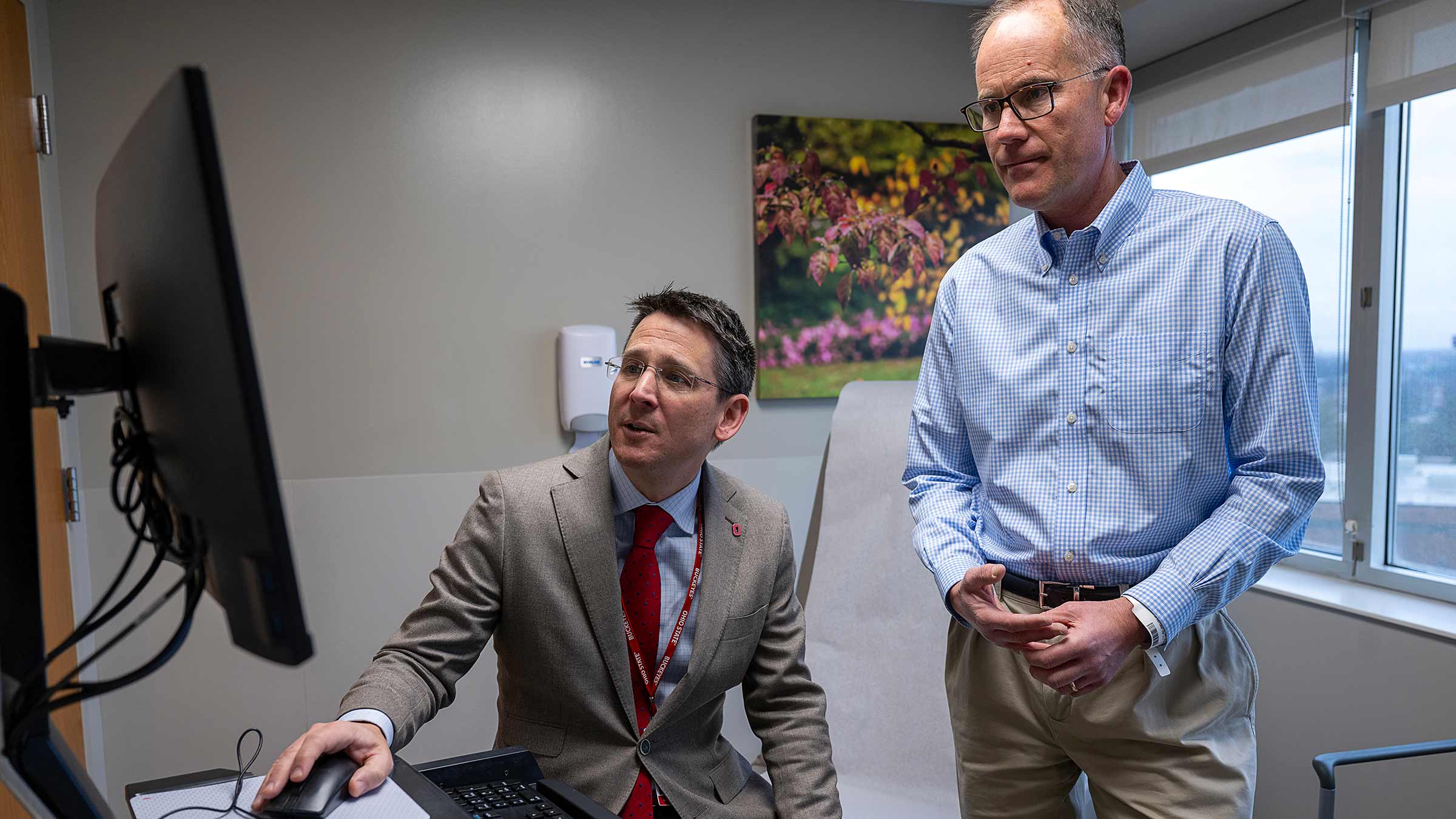 Dr. Pawlik with Bob Berry looking at a computer screen in an exam room