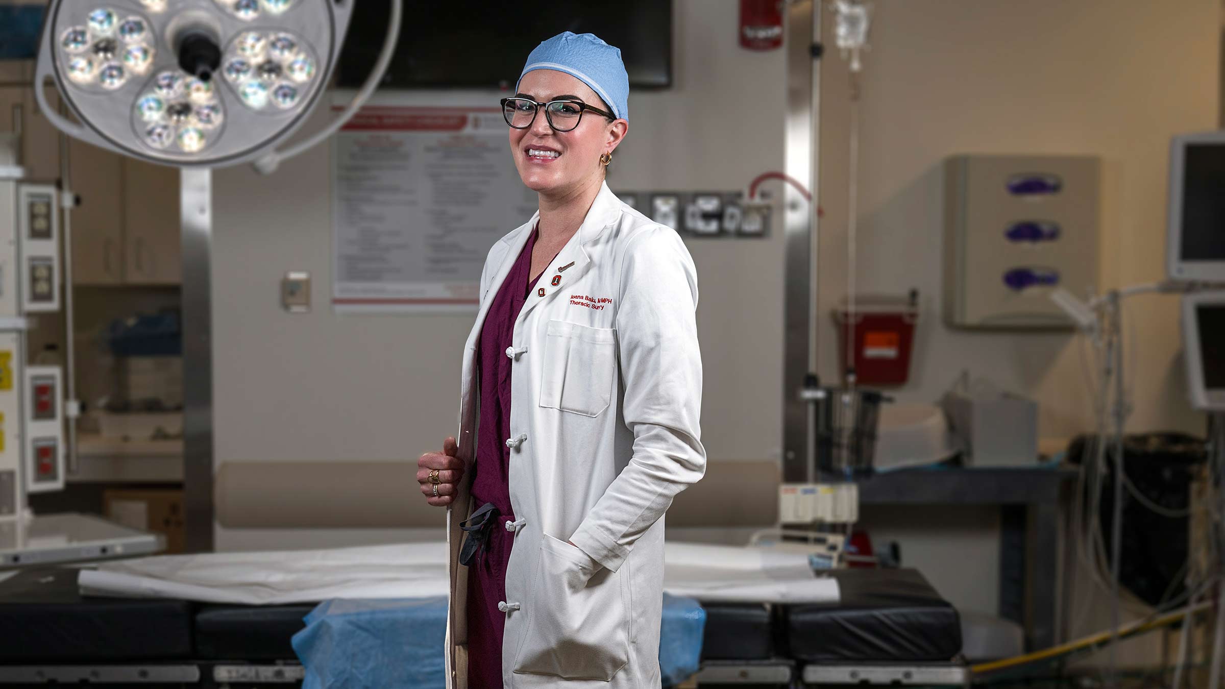 Dr. Ioana Baiu standing in her medical uniform in an operating room