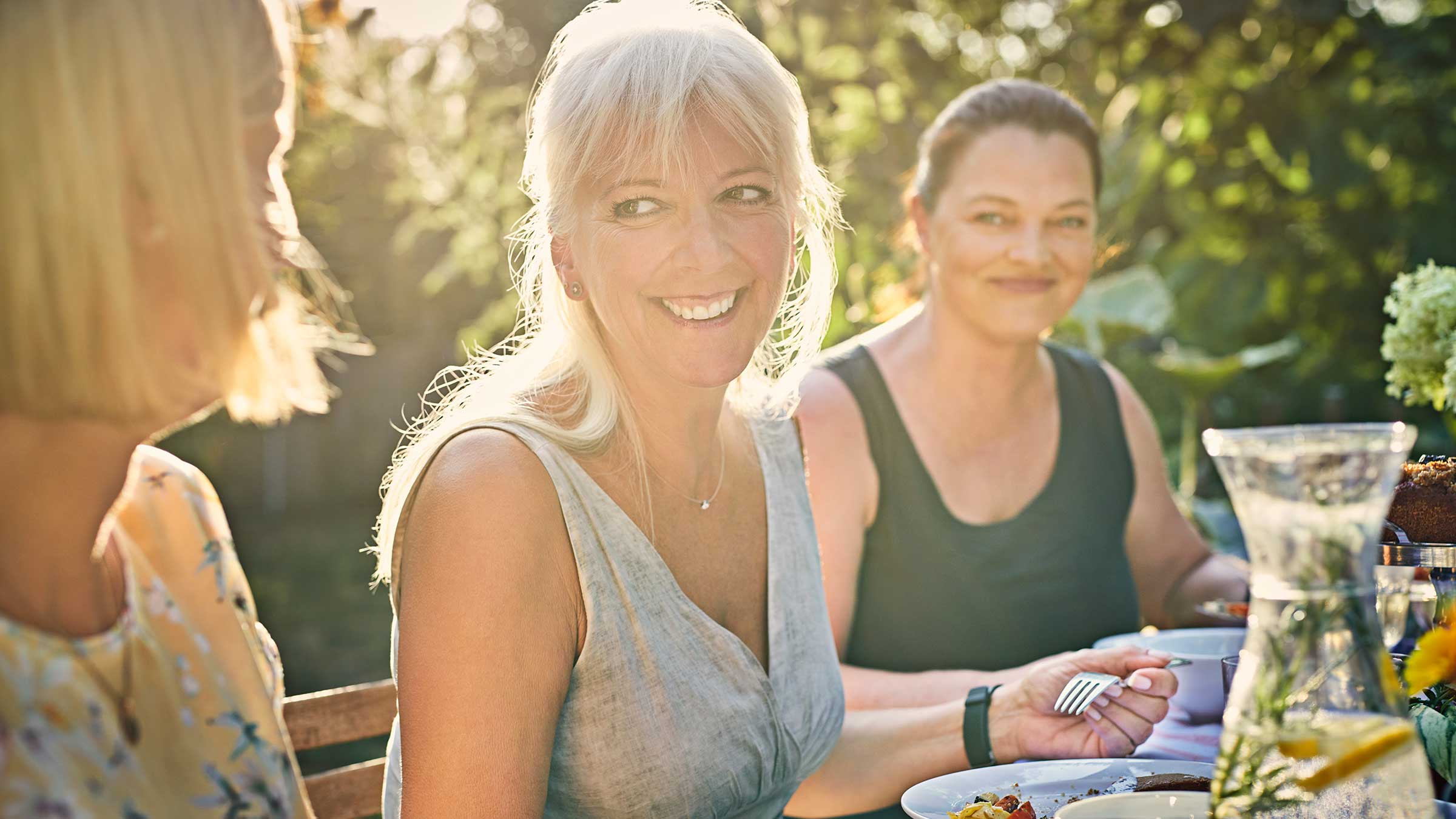 A group of middle-aged women gathering at a garden party