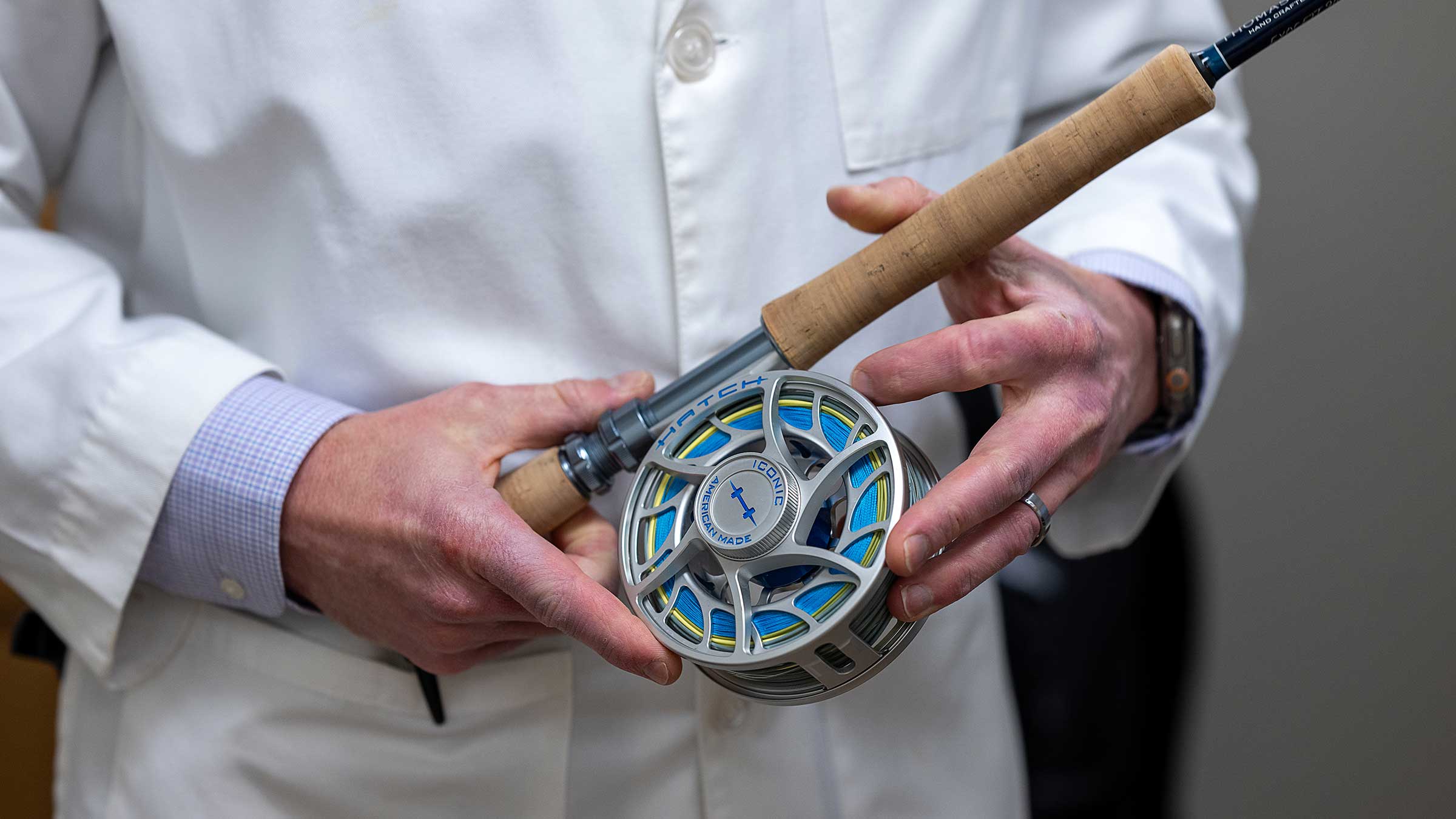 Dr. Old holding a fishing rod