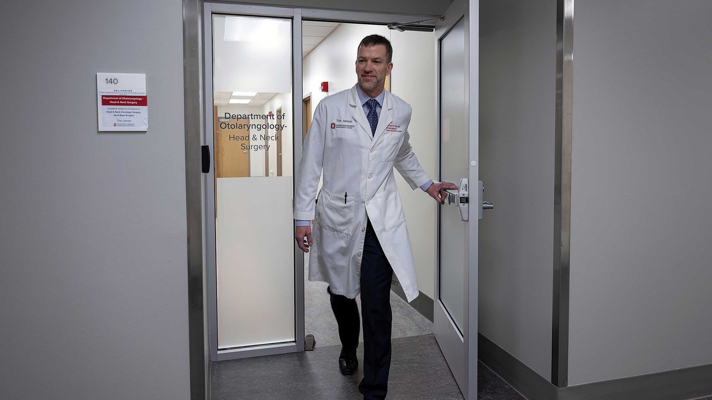 Dr. Old walking out the door of the Head and Neck Surgery