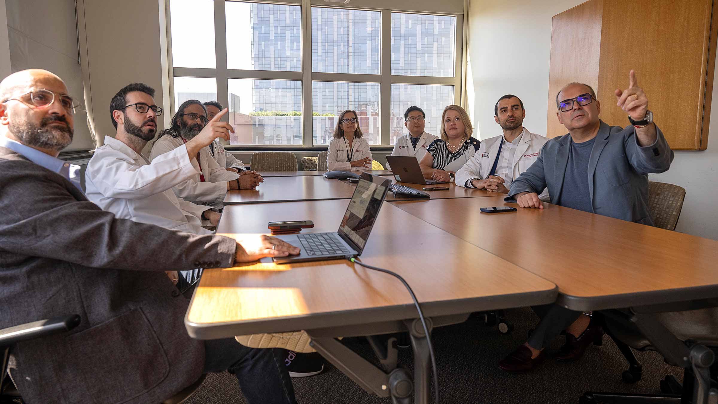 Dr. Christian Rolfo and his medical team in a conference room