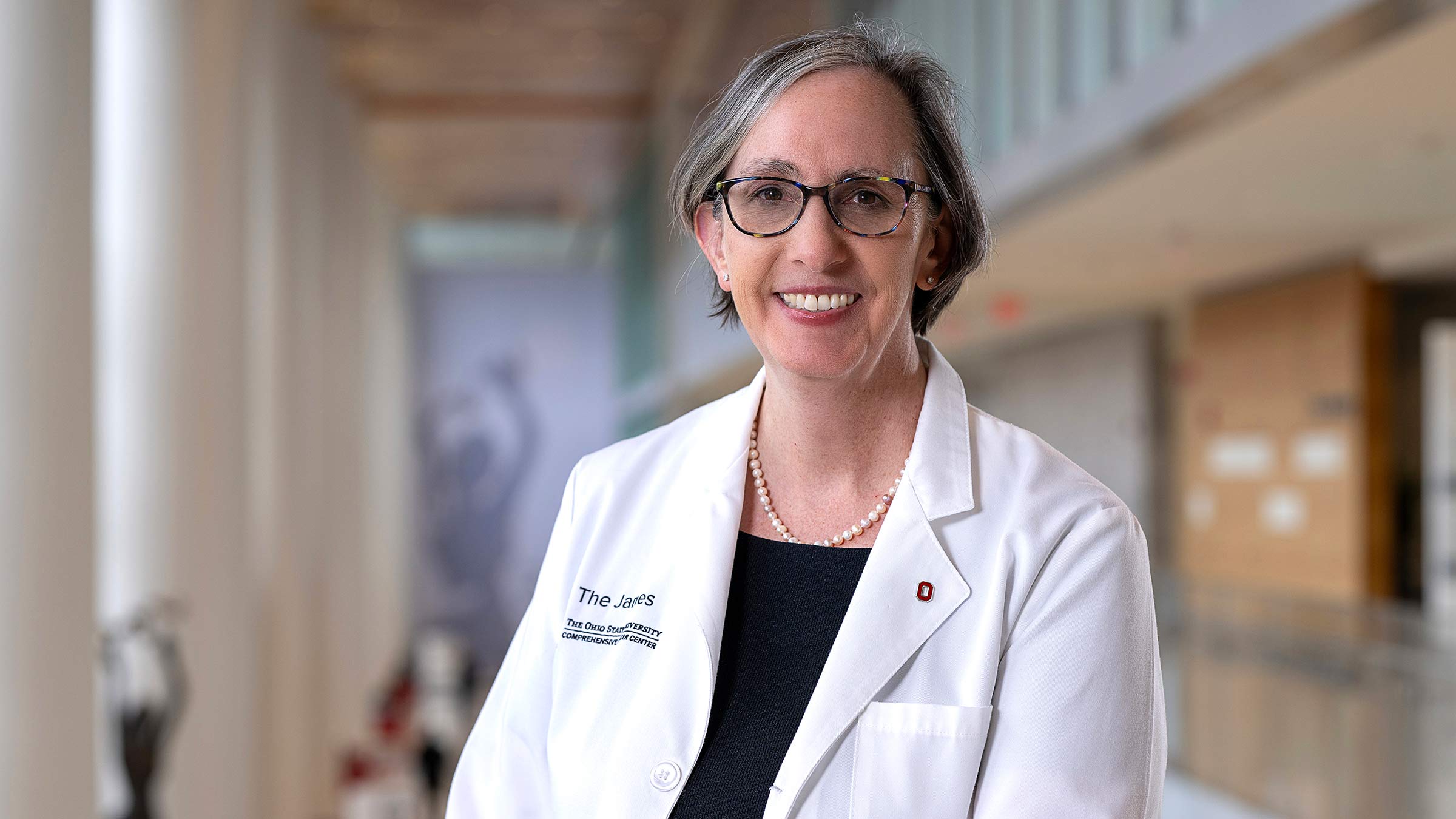 Dr. Kimryn Rathmell in a white coat