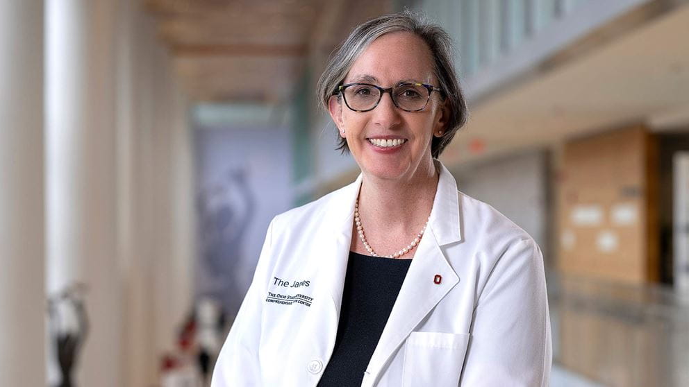 Dr. Kimryn Rathmell in a white coat