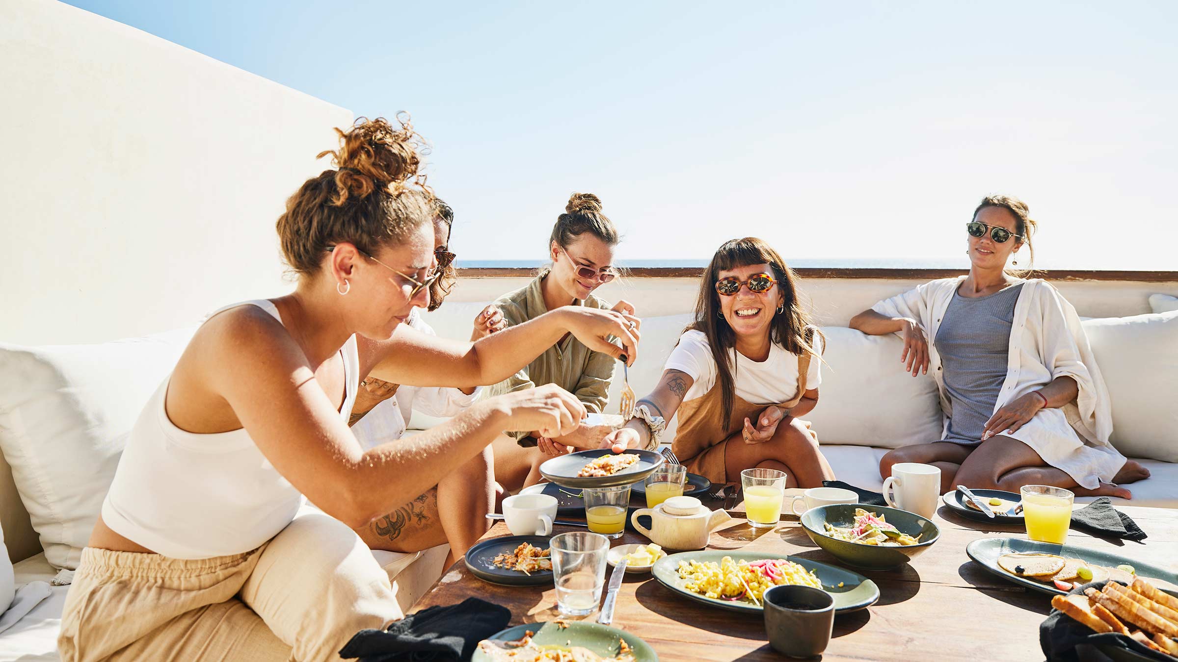 A group of young women sharing breakfast at a resort
