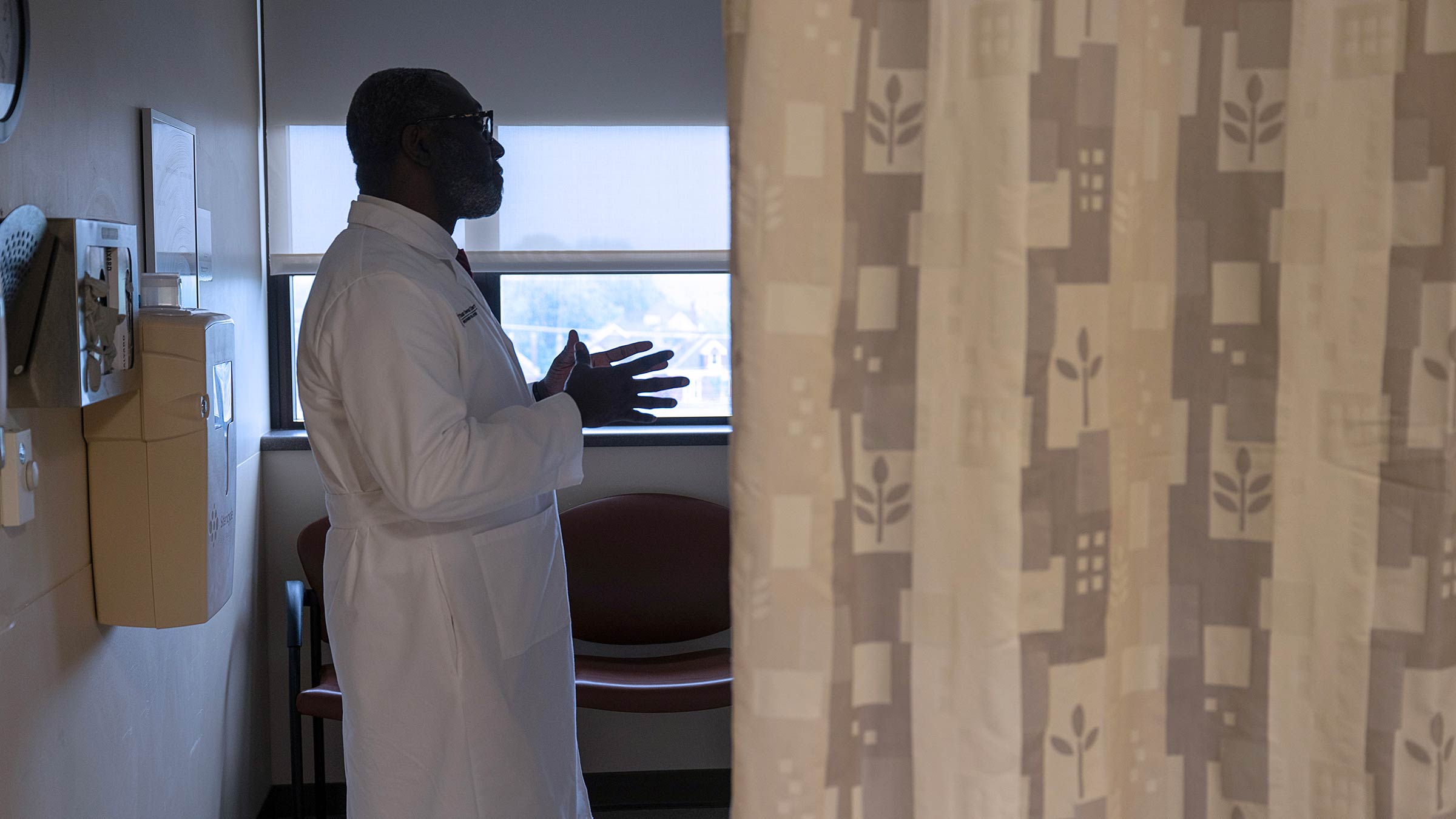 Dr. Oriowo visiting a patient in the hospital room