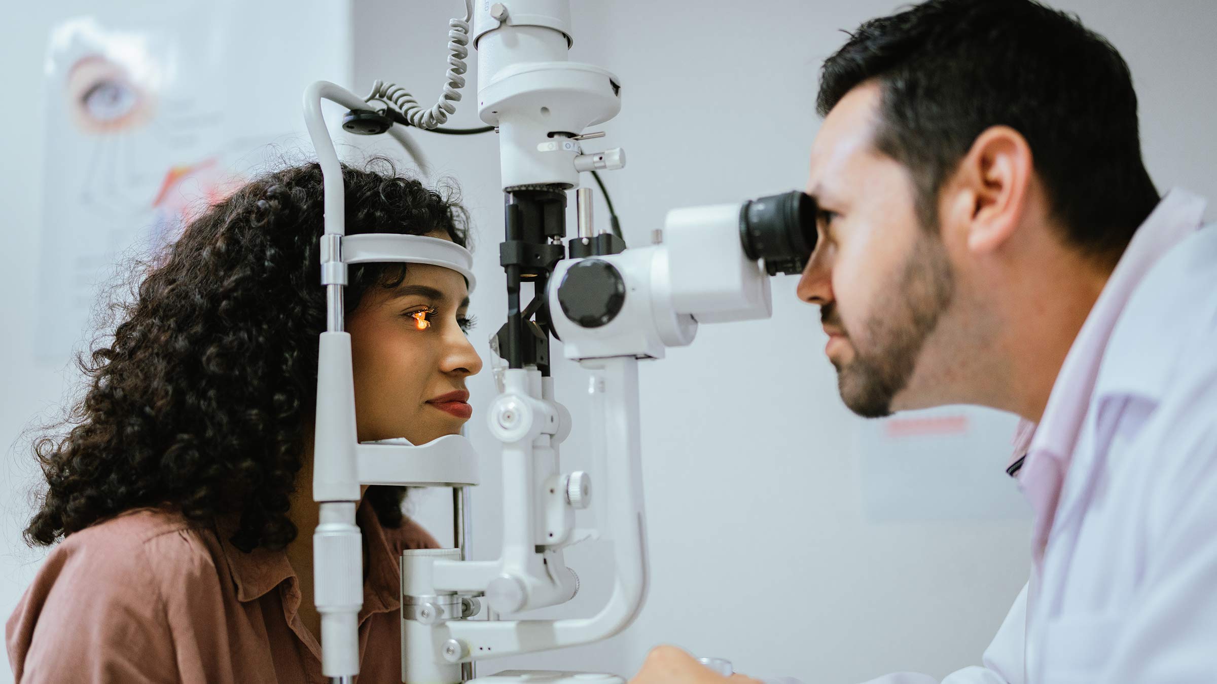 A young woman undergoing an eye exam with an optometrist
