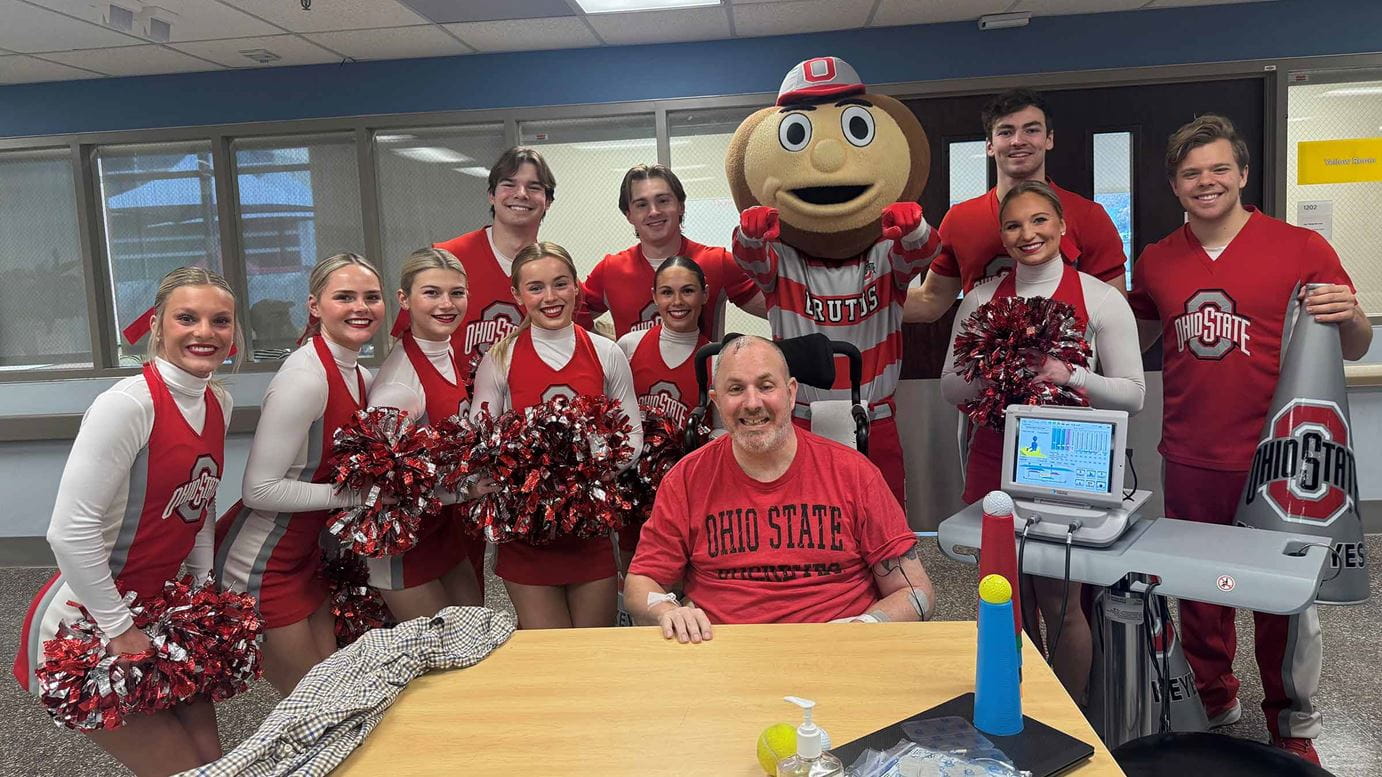 Jeremy Phalen surrounded by Ohio State cheerleaders and Brutus
