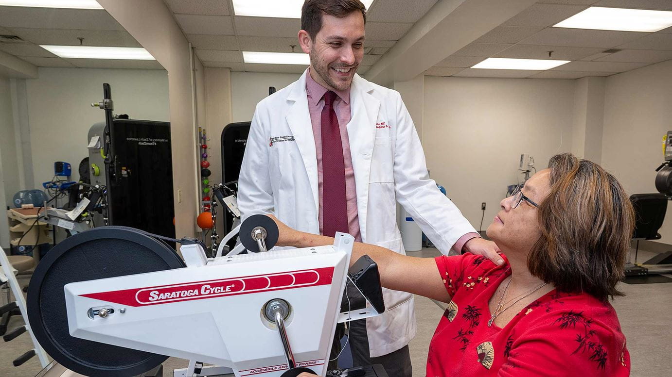 Dr. Hake observes a patient during physical therapy