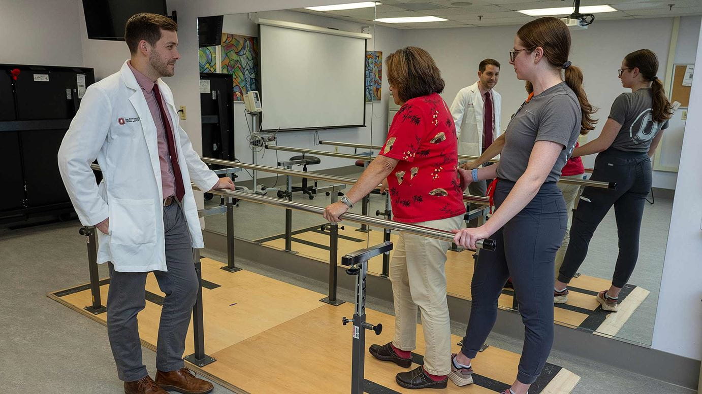 Dr. Hake observes a patient learning to walk