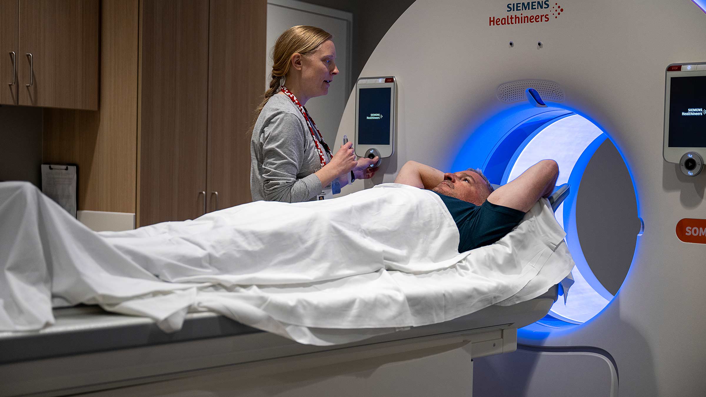 Brian Bognar lying on the scanning table, preparing to undergo a CT scan