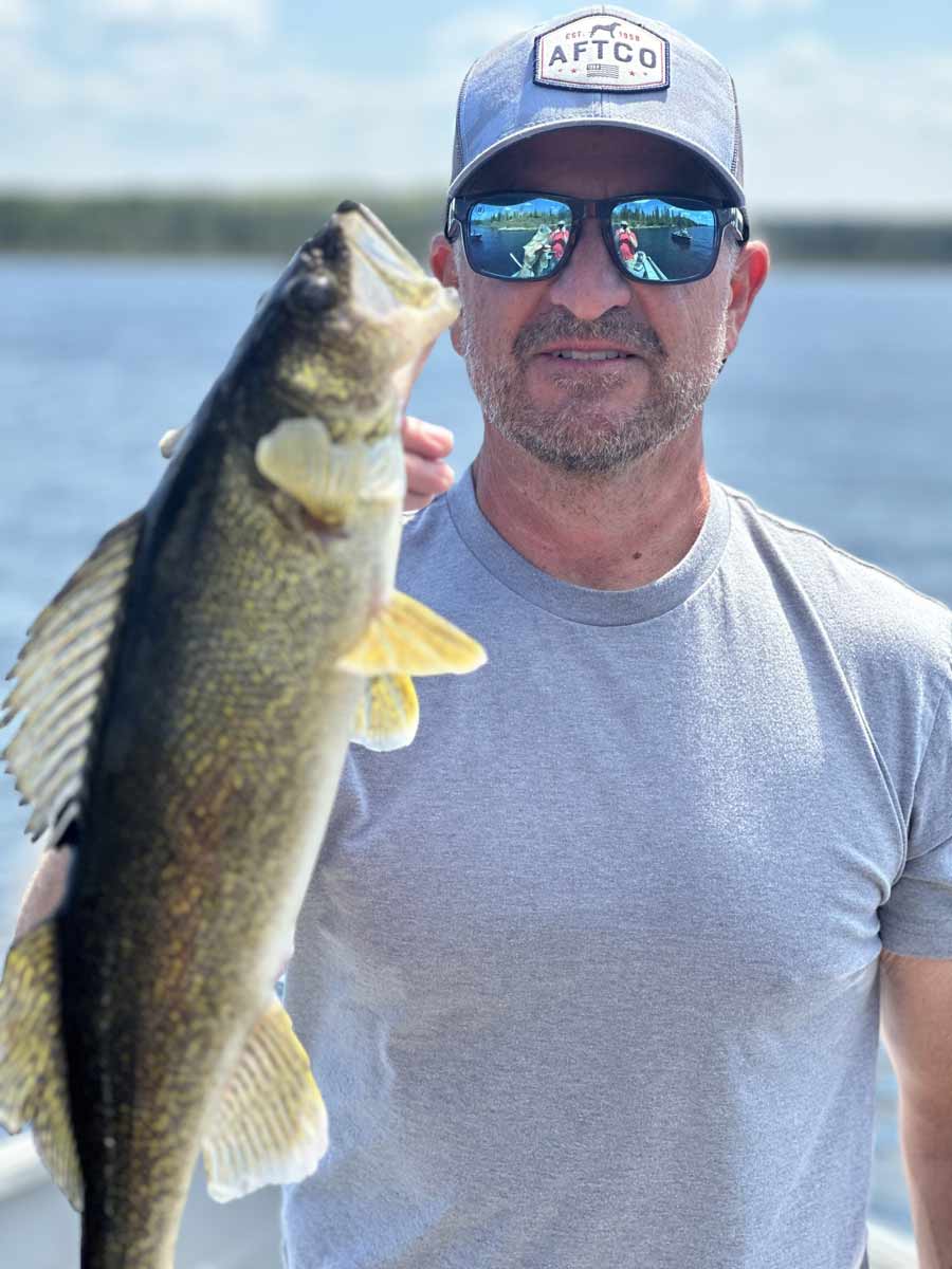 Brian Bognar holding a fish he just caught