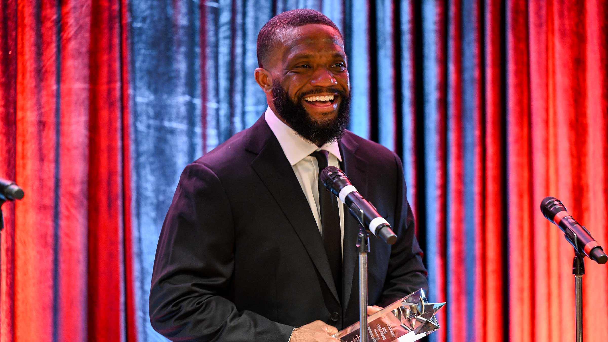 Maurice Clarett accepting an award for mental health