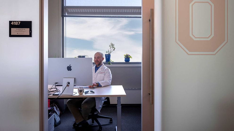 Dr. Thomas Mendel in his office looking at his computer