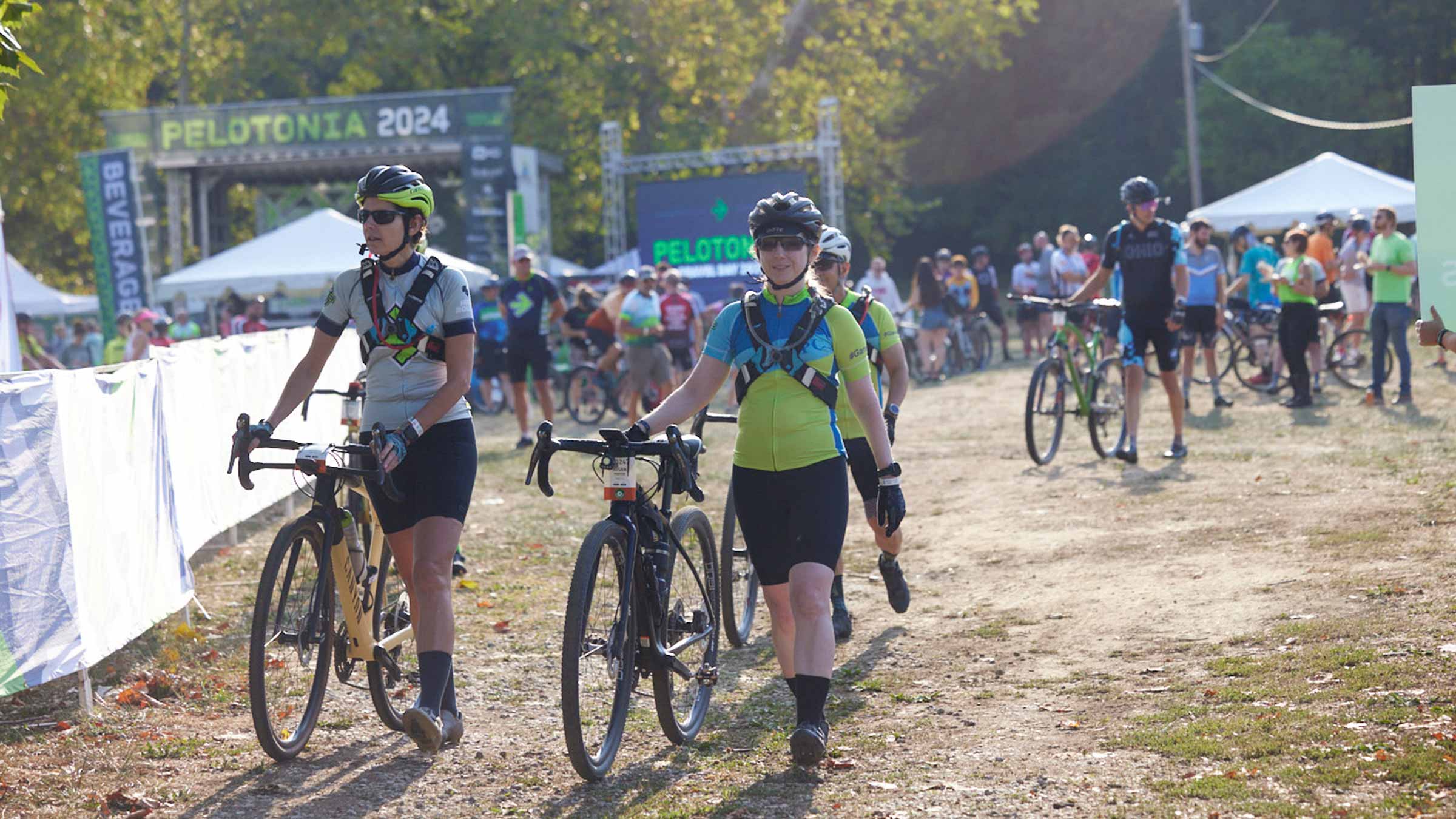 Riders walking next to their bikes