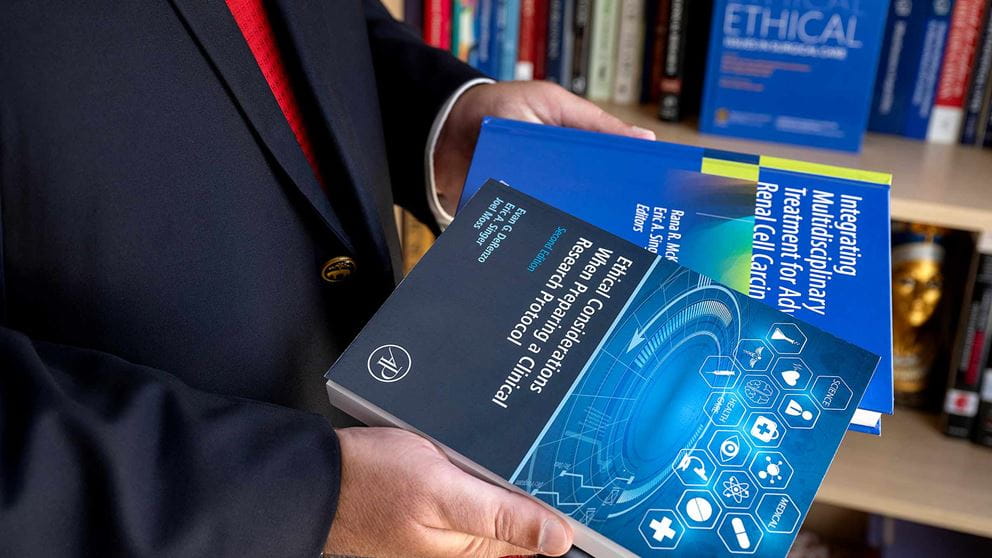 Dr. Singer showing his books