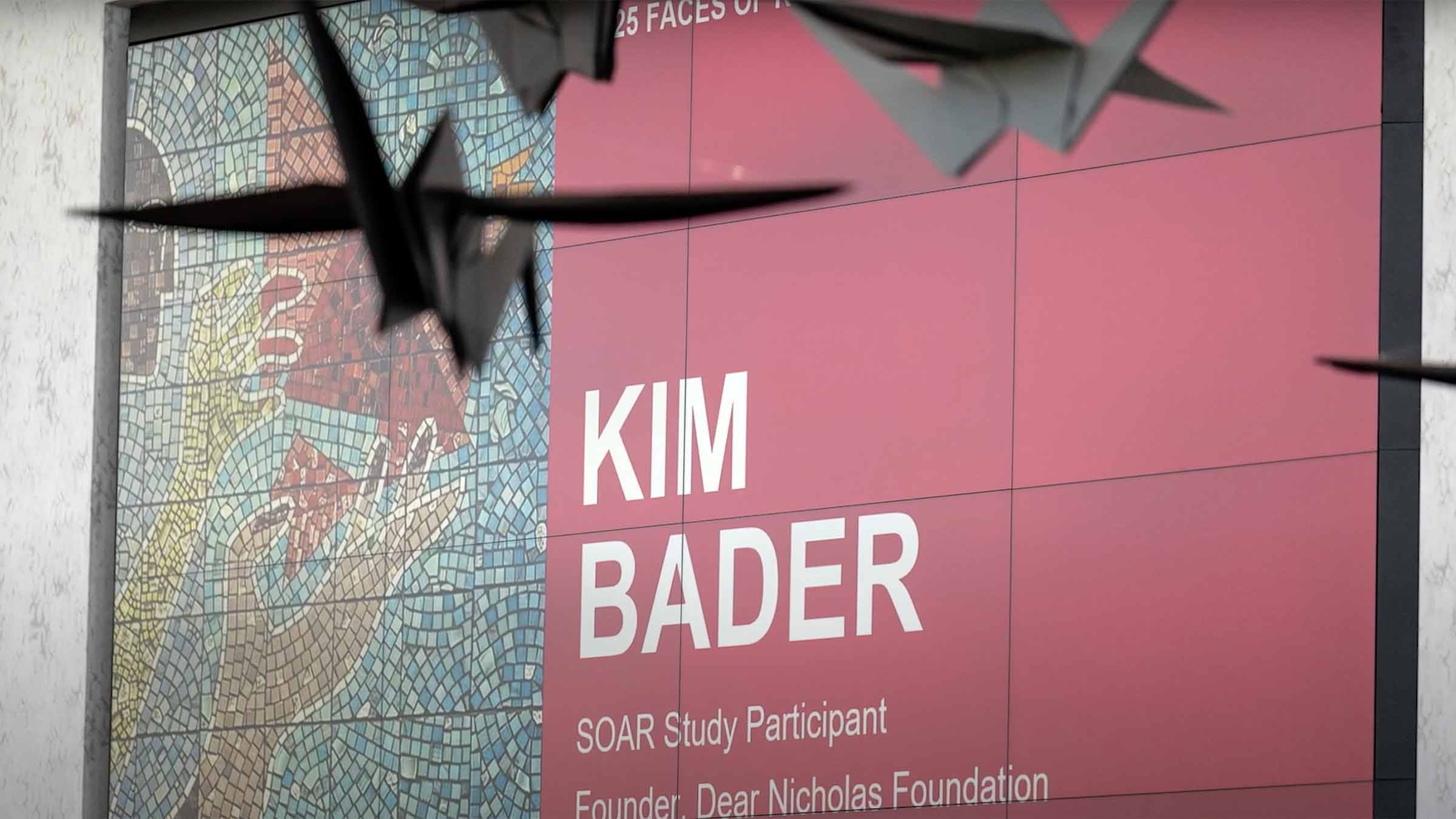 Word on the screen announcing Kim Bader