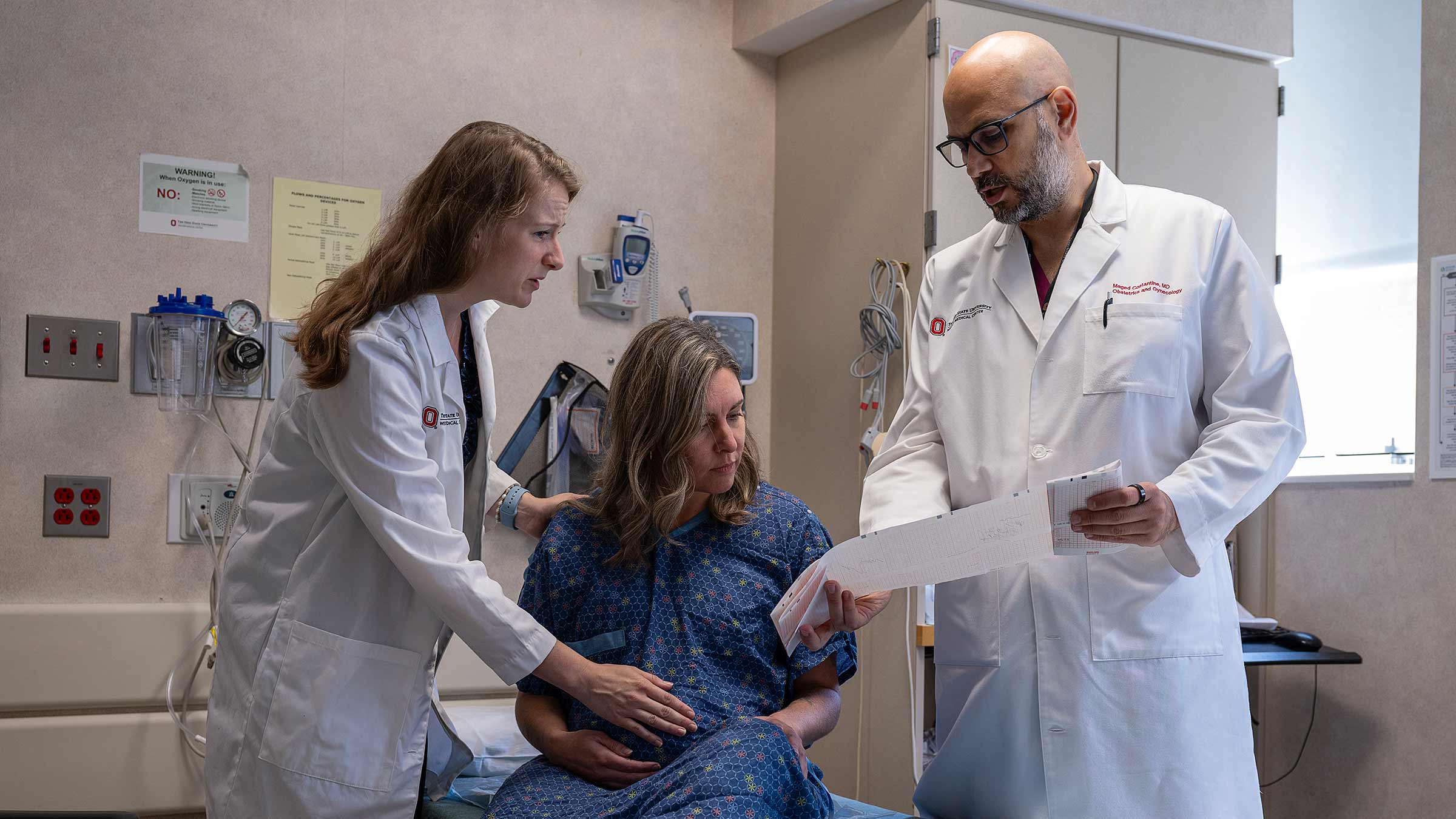 Dr. Maged Costantine (right) and Dr. Tracy Caroline Bank (left) talking to a patient