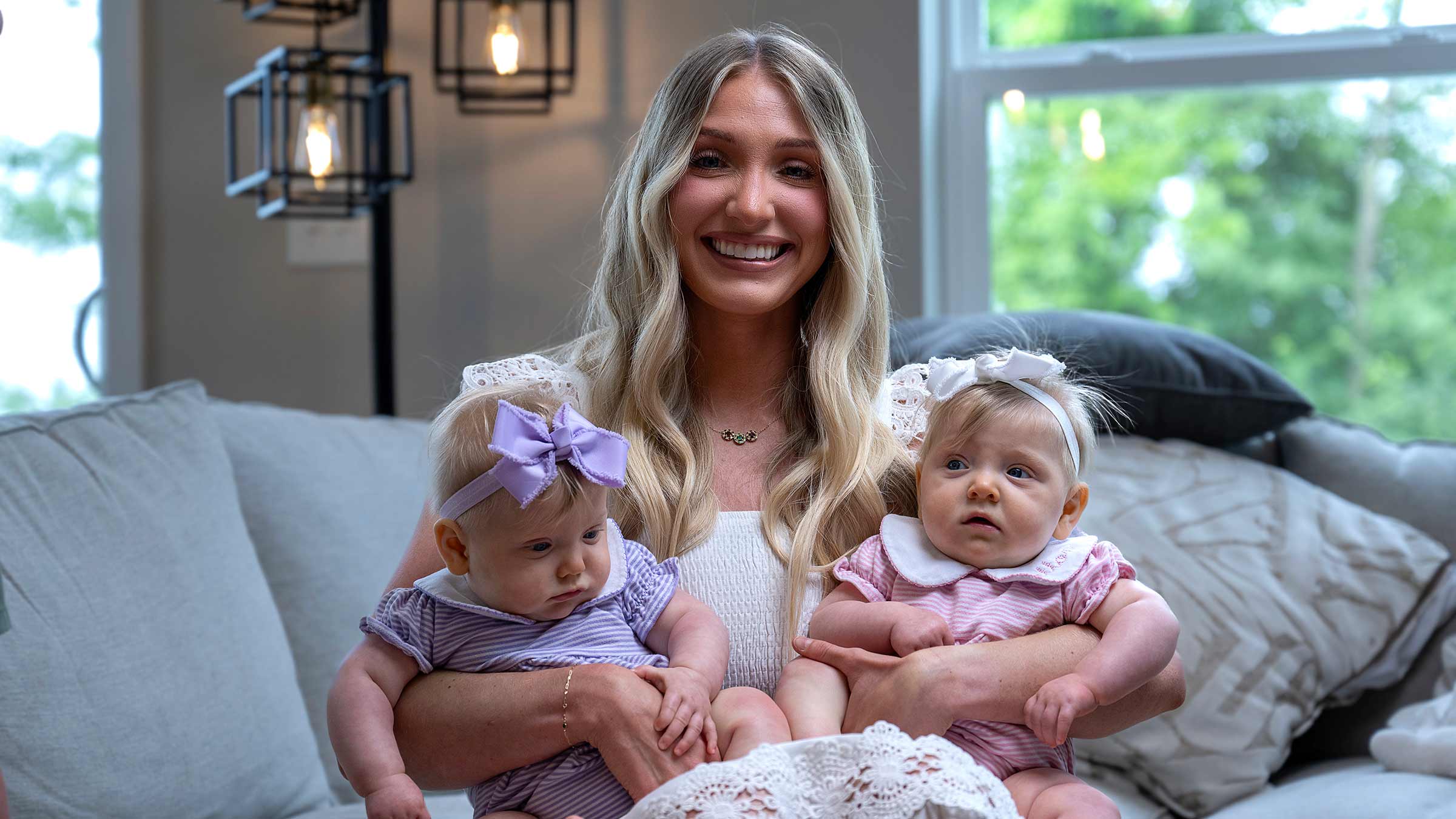 Madison Feinberg holding her MoMo twin daughters, Sutton and Callahan