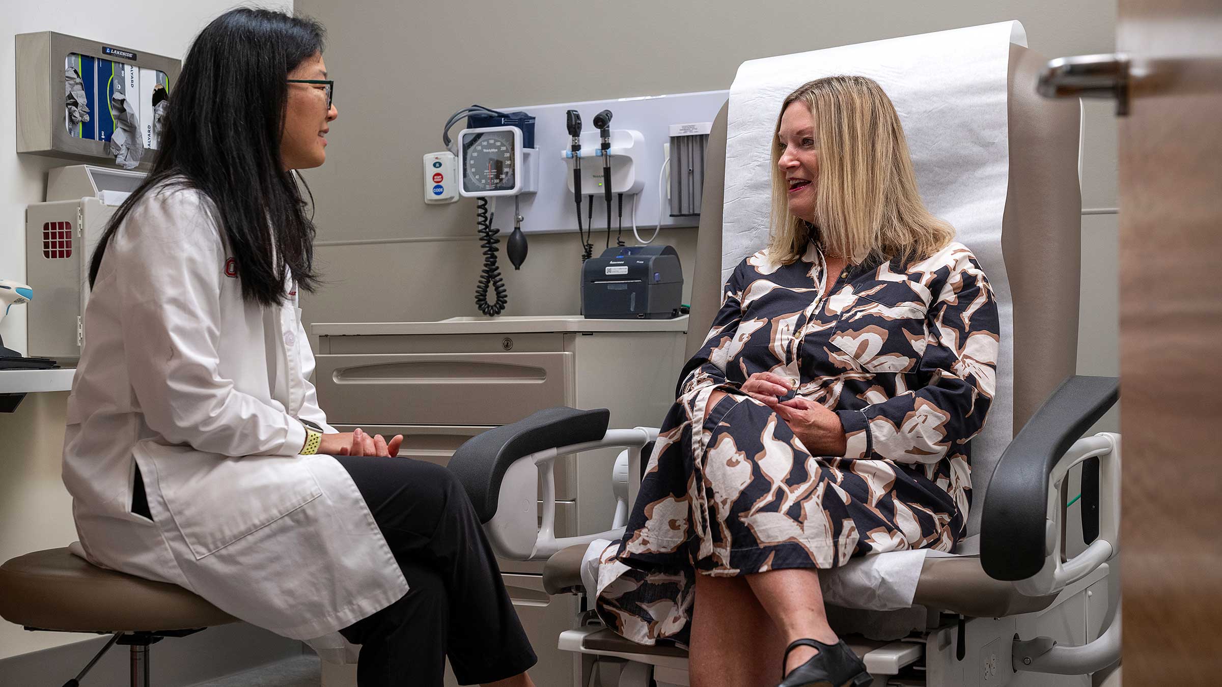 Julia DeVillers talking to Dr. Huang in an exam room