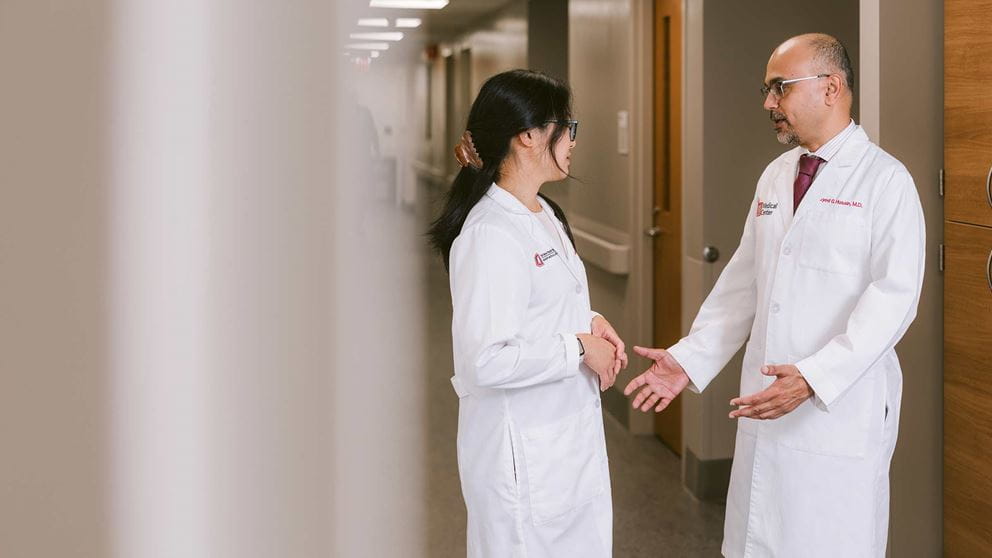 Dr. Huang and Dr. Husain talking in the hallway