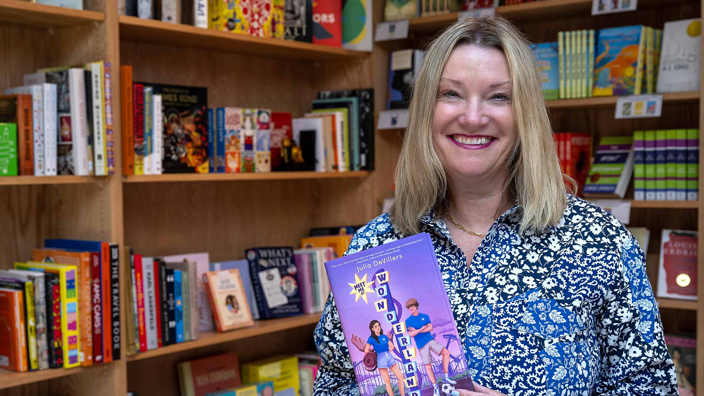 Julia DeVillers holding her book in a bookstore