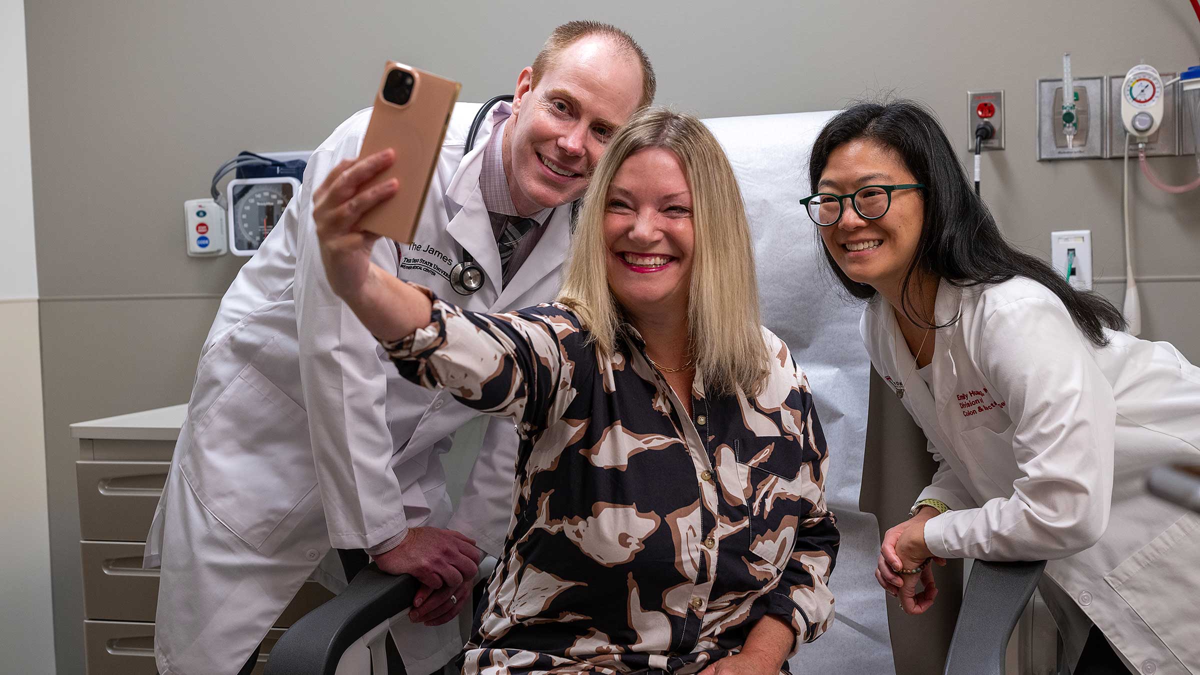 Julia DeVillers taking a selfie with Dr. Miller (left) and Dr. Huang (right)