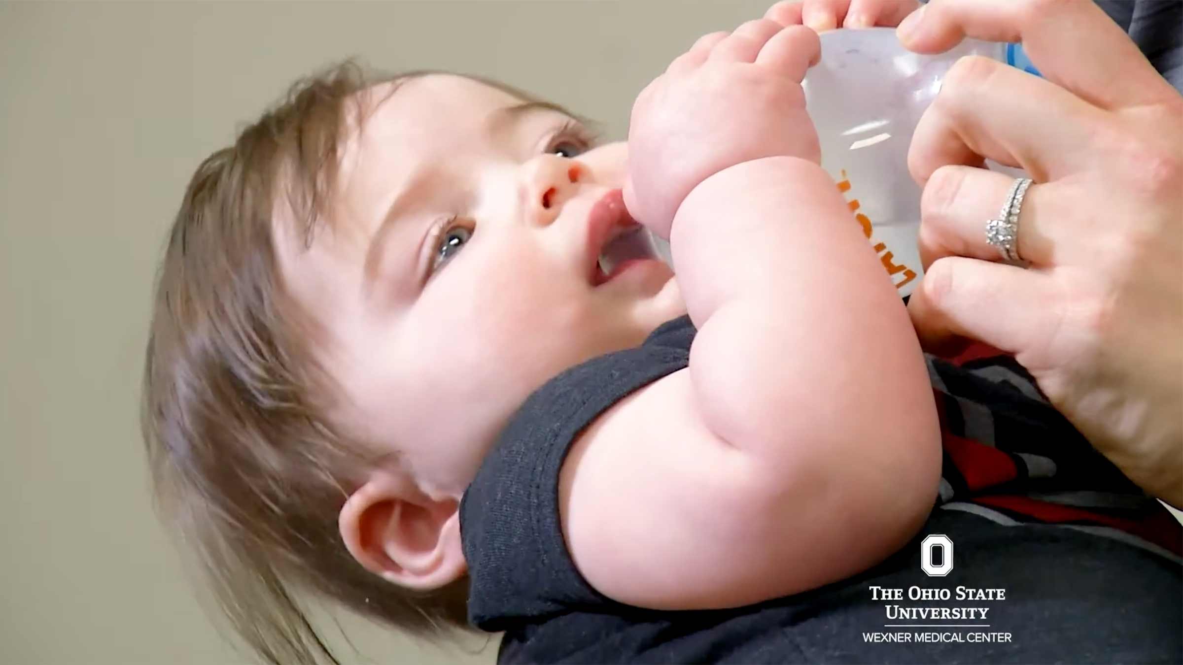 A baby holding a bottle