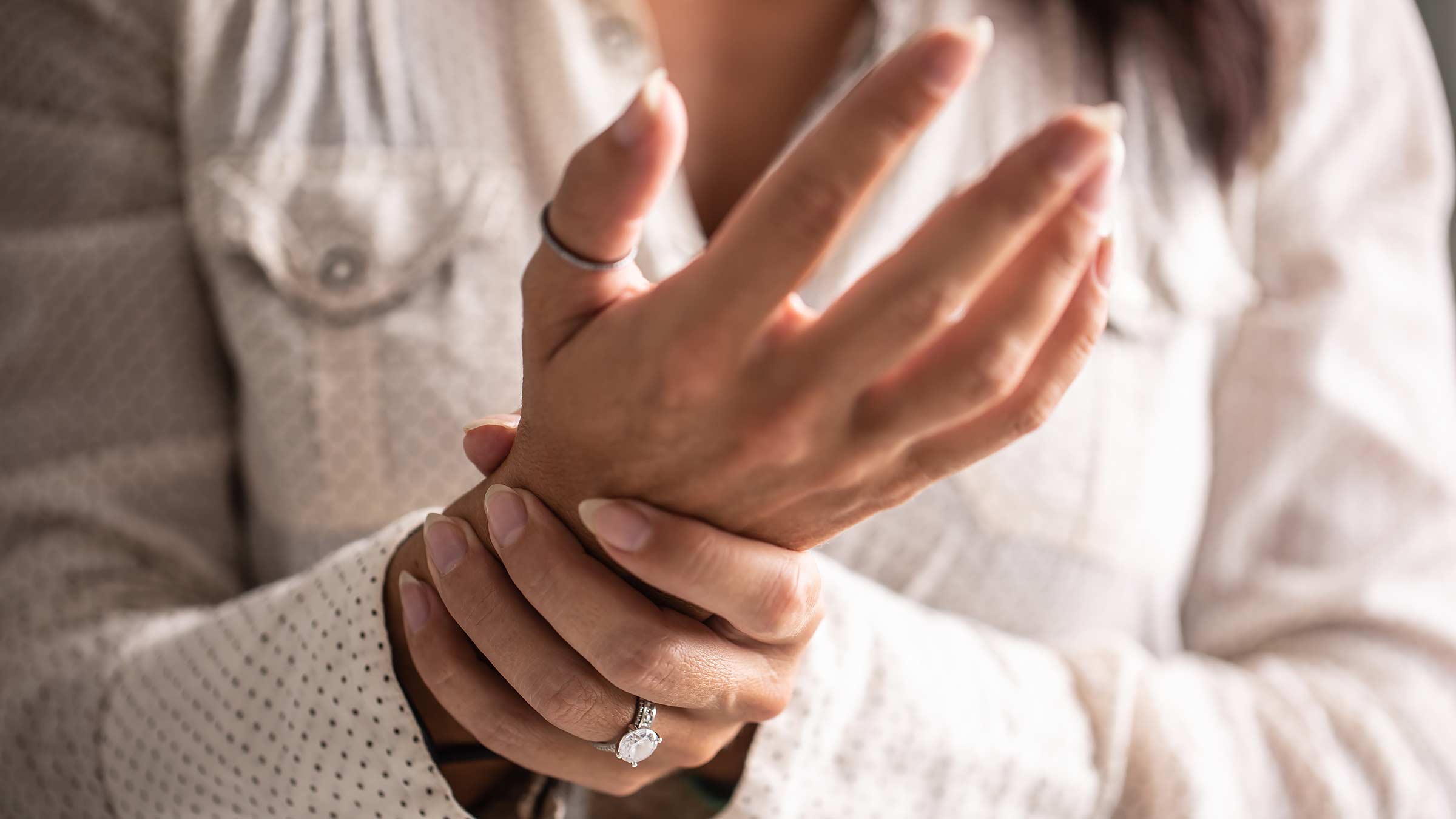 Close up of a woman holding her wrist