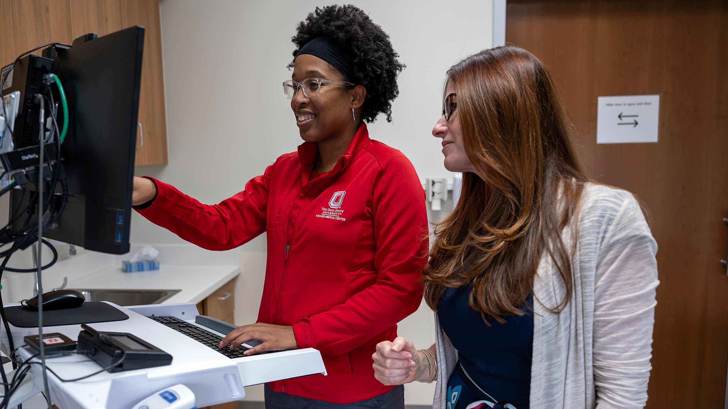 Dr. Becker with a colleague looking at the computer screen