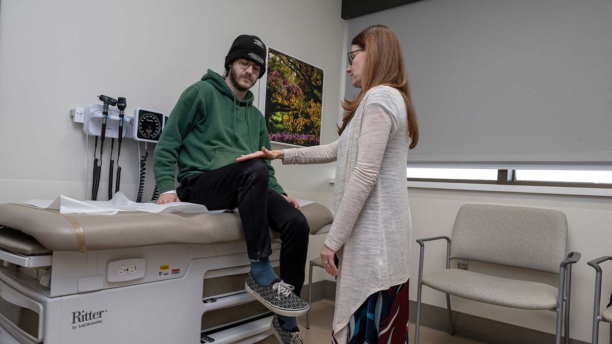Noah Braholli in the exam room with a doctor