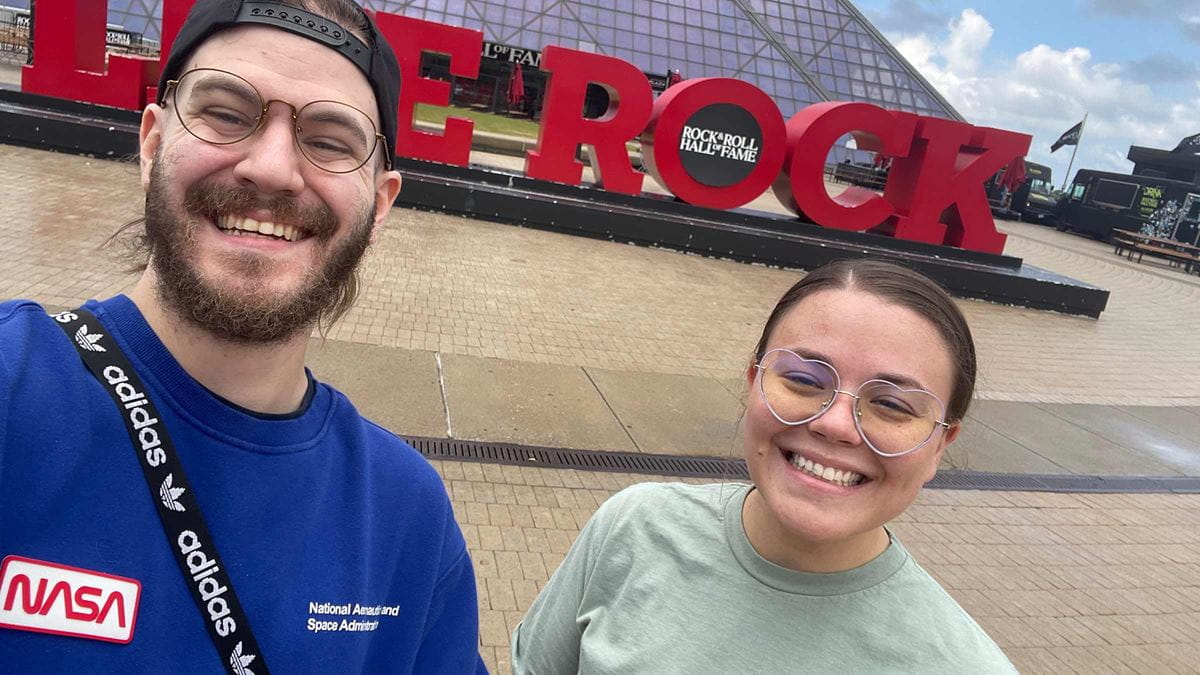 Noah Braholli with his partner, Ripley Villers, next to a Hard Rock Cafe