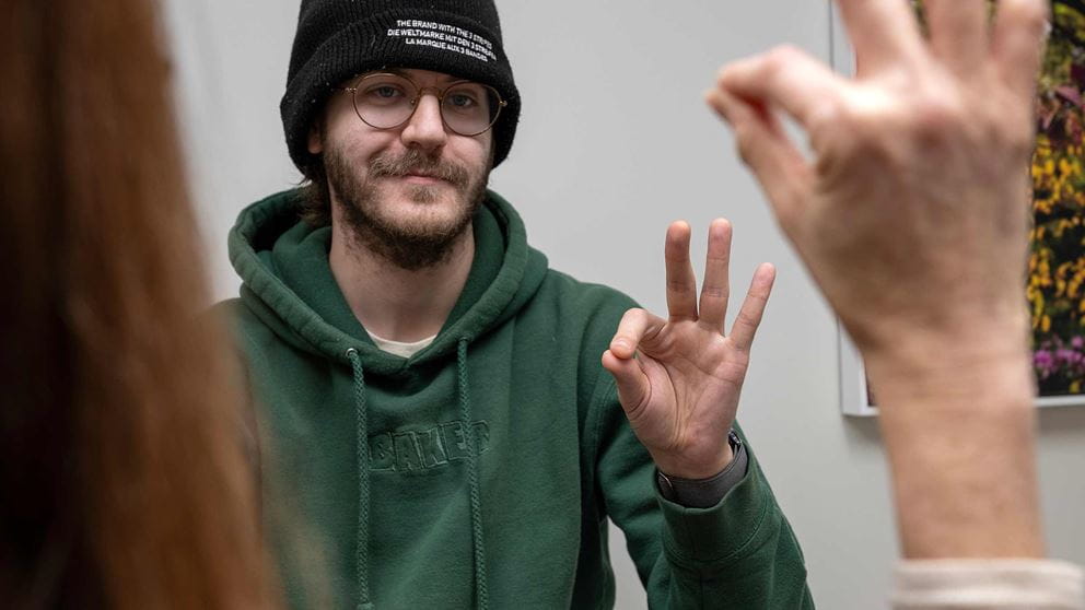 Noah Braholli doing a test with his doctor, touching his thumb and index finger together