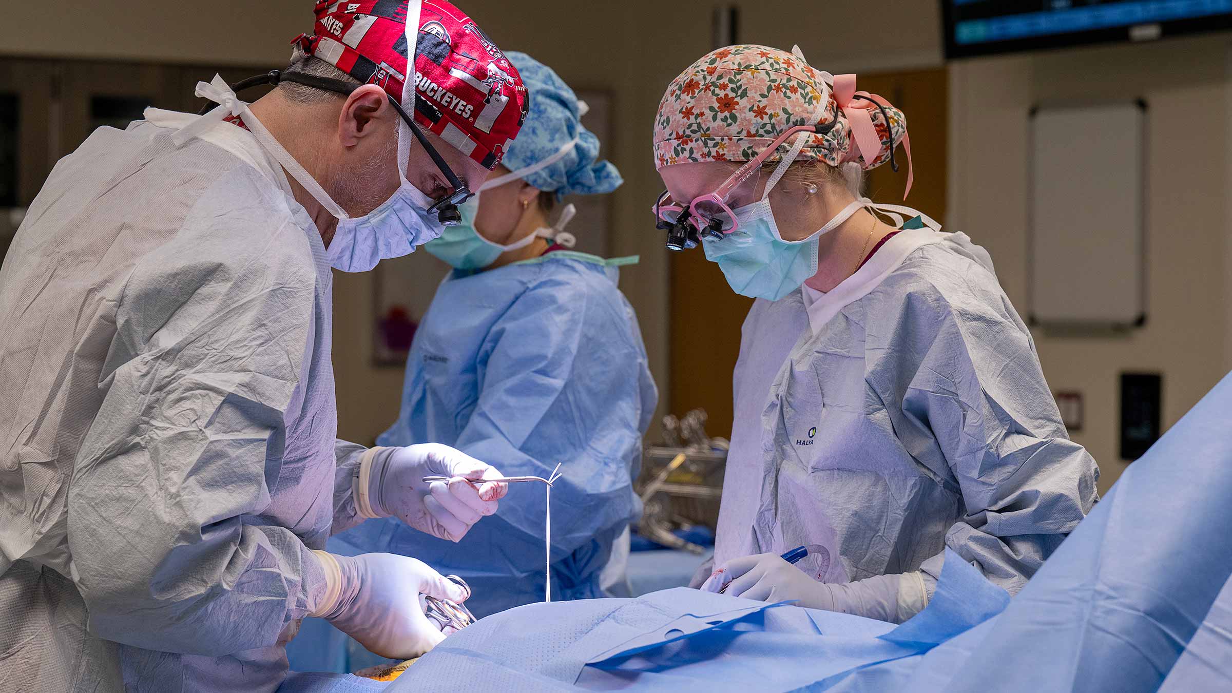 Matthew Corriere in the operating room performing a surgery