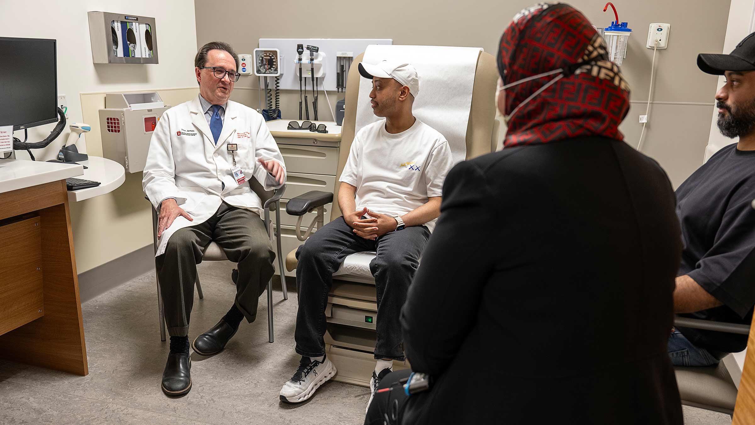Doctor Marcos de Lima speaking with patient Khaled Alsheebani in an exam room