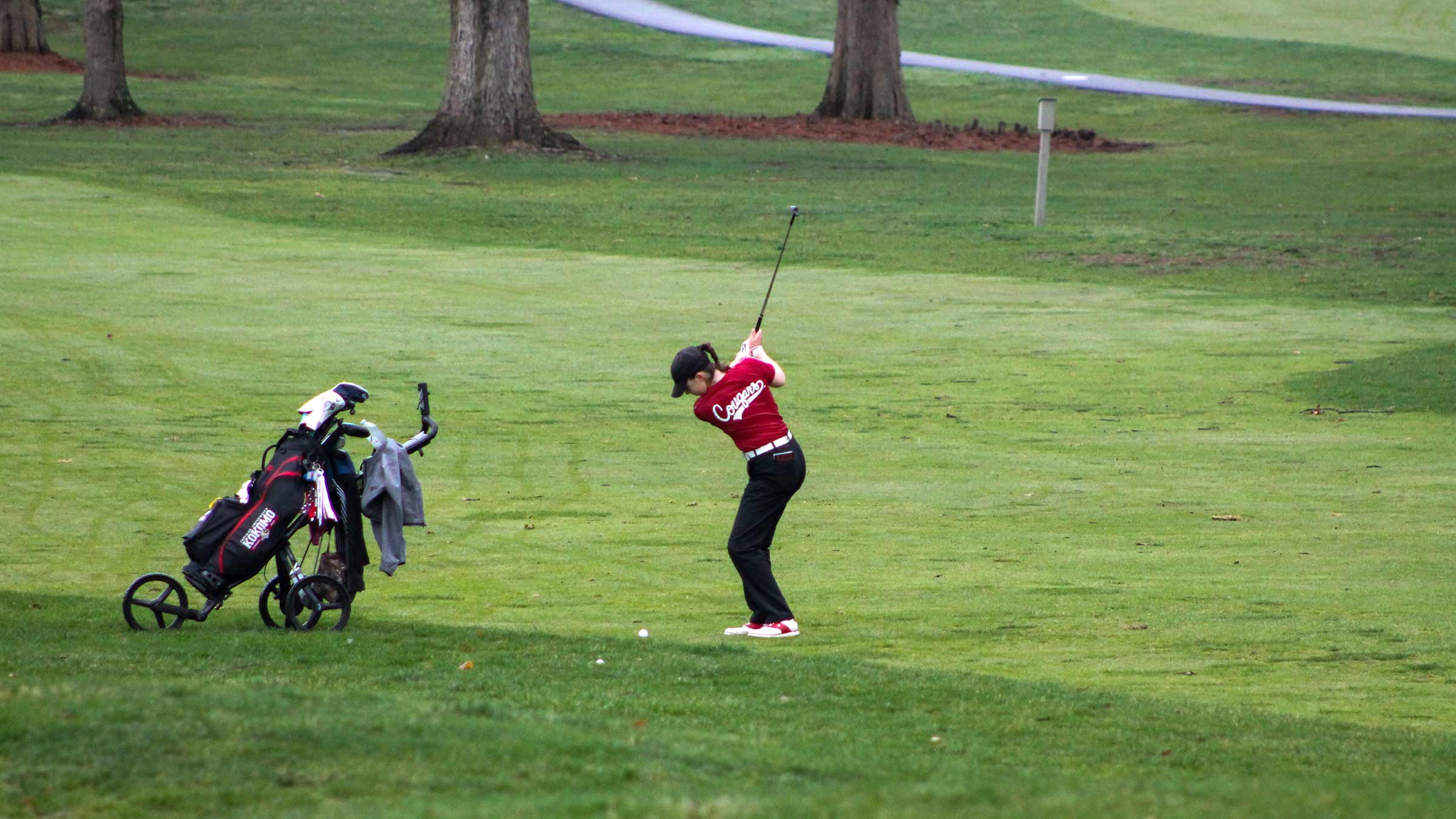 Hailey Stegemann getting ready to hit a golf ball on a grassy course